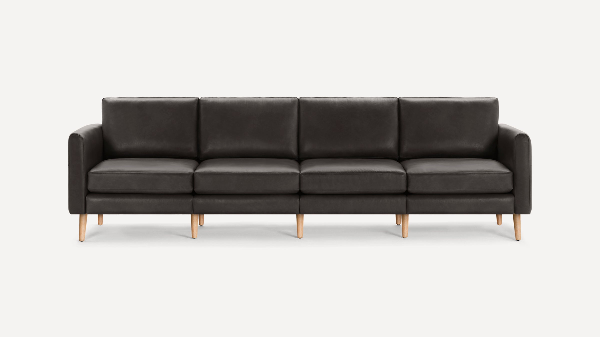 Modern dark gray leather sofa with four seat cushions and wooden legs, featuring clean lines and a minimalist design.