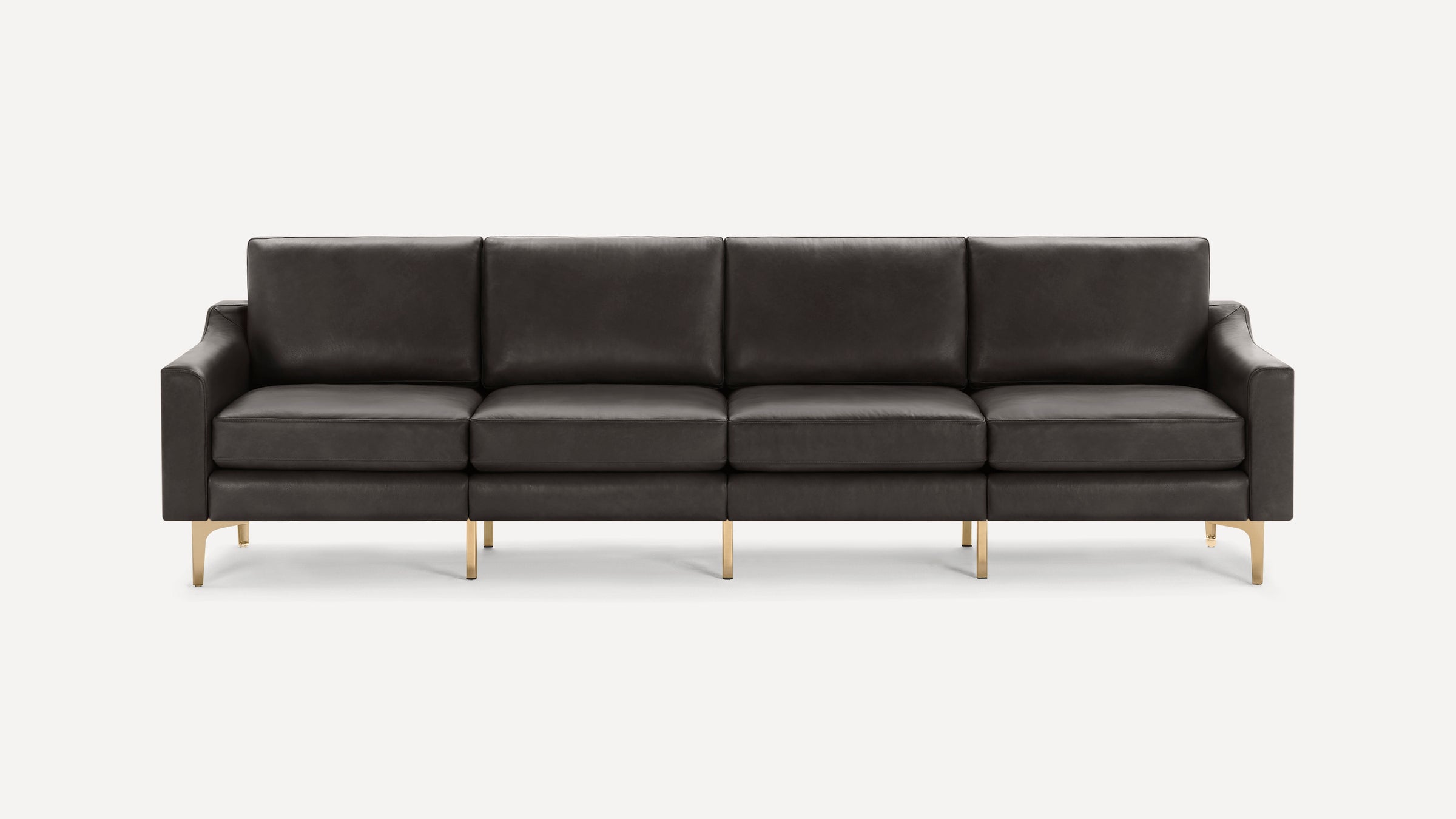 Modern four-seater sofa with dark gray leather upholstery and slim gold metal legs on a white background.