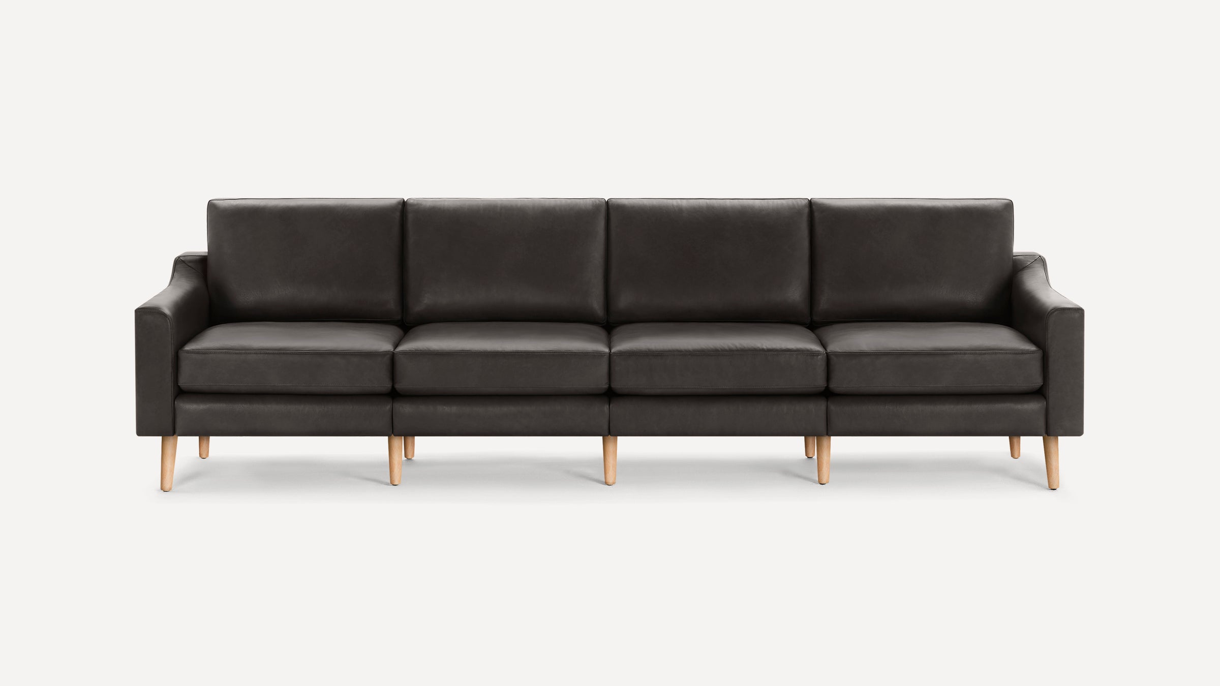 Dark gray modern four-seater sofa with clean lines, cushioned seats, and light wooden tapered legs on a white background.