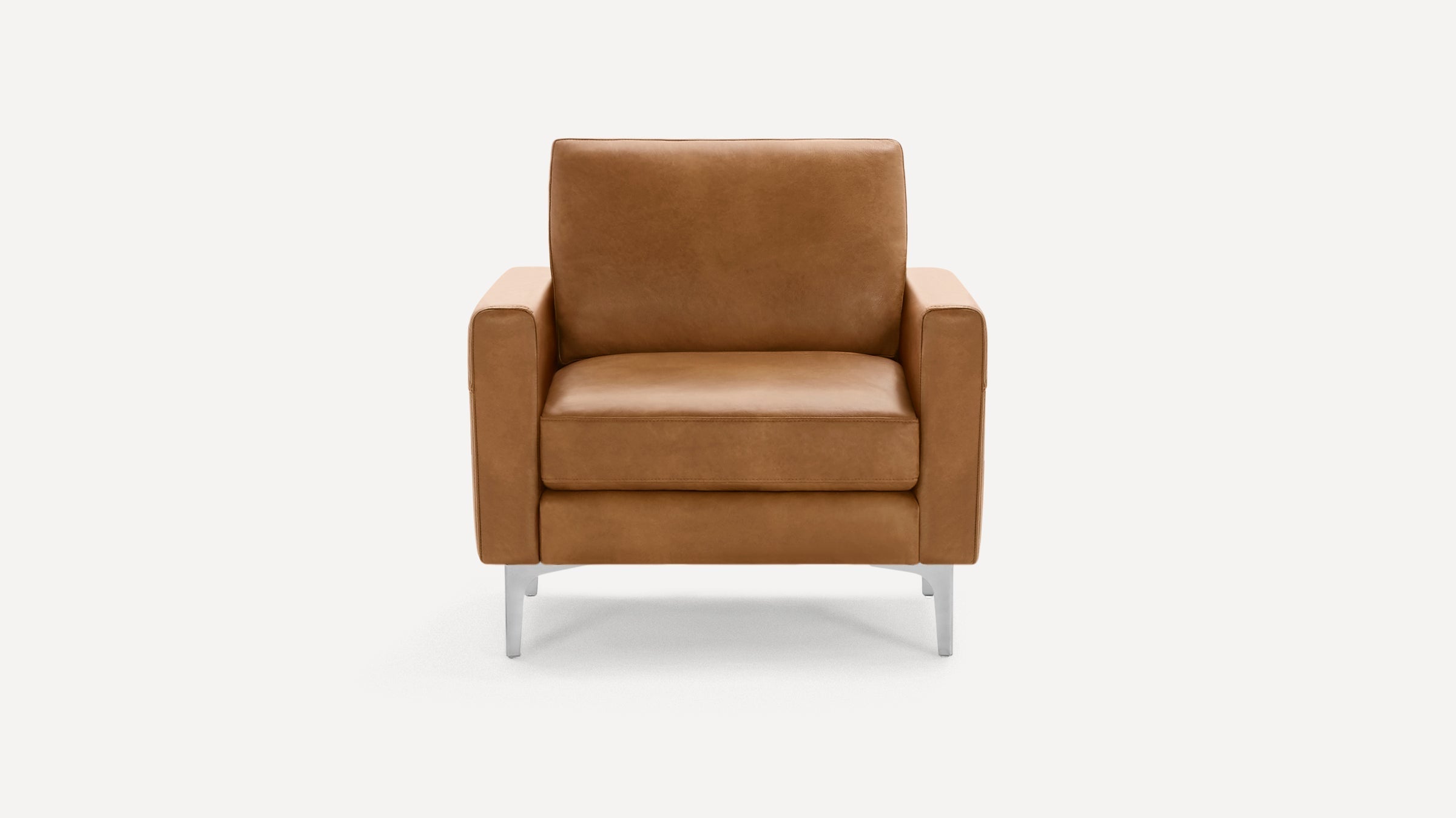 Front view of a modern tan leather armchair with straight arms and metal legs on a plain white background.