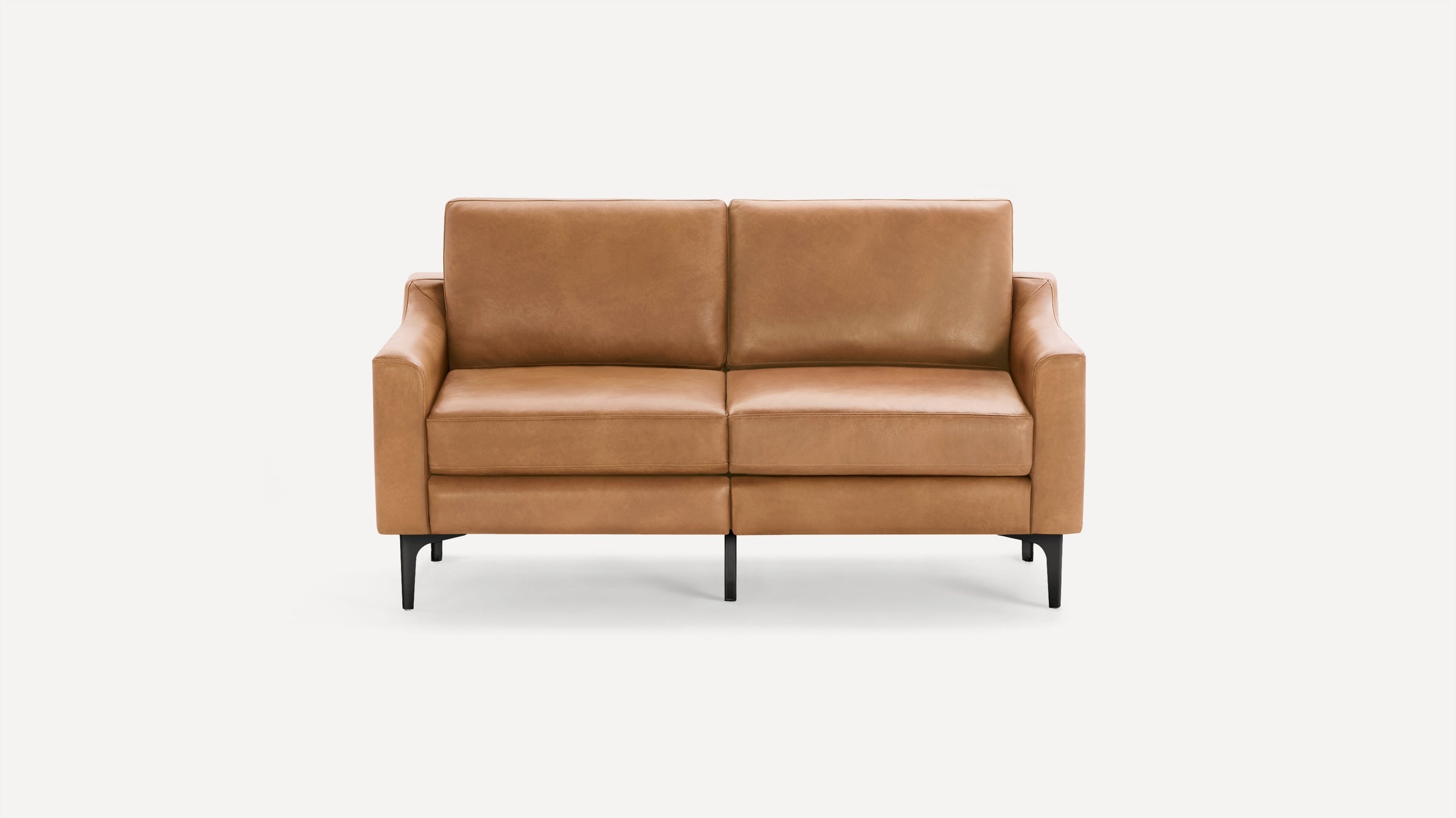 Tan leather loveseat with clean lines, slim black legs, and cushioned seats and backrests on a white background.