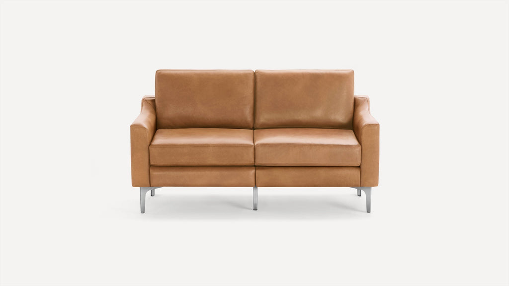 Modern two-seater sofa with tan leather upholstery, square armrests, and sleek metal legs on a white background.