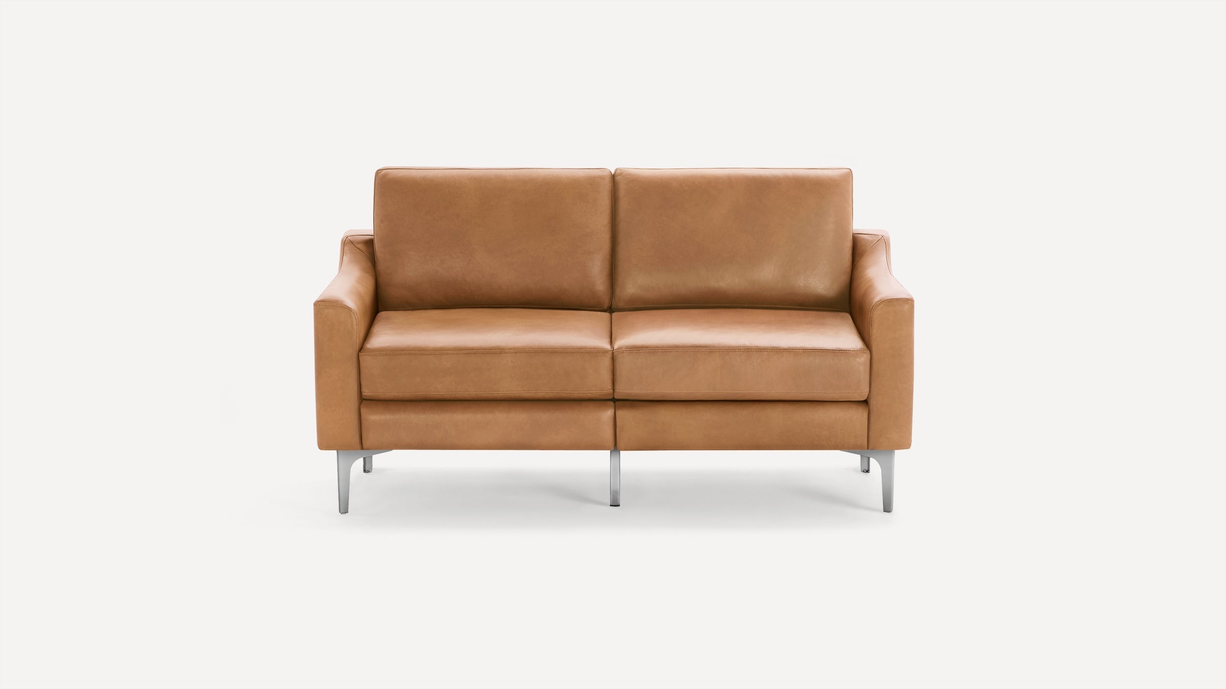 Modern two-seater sofa with tan leather upholstery, square armrests, and sleek metal legs on a white background.