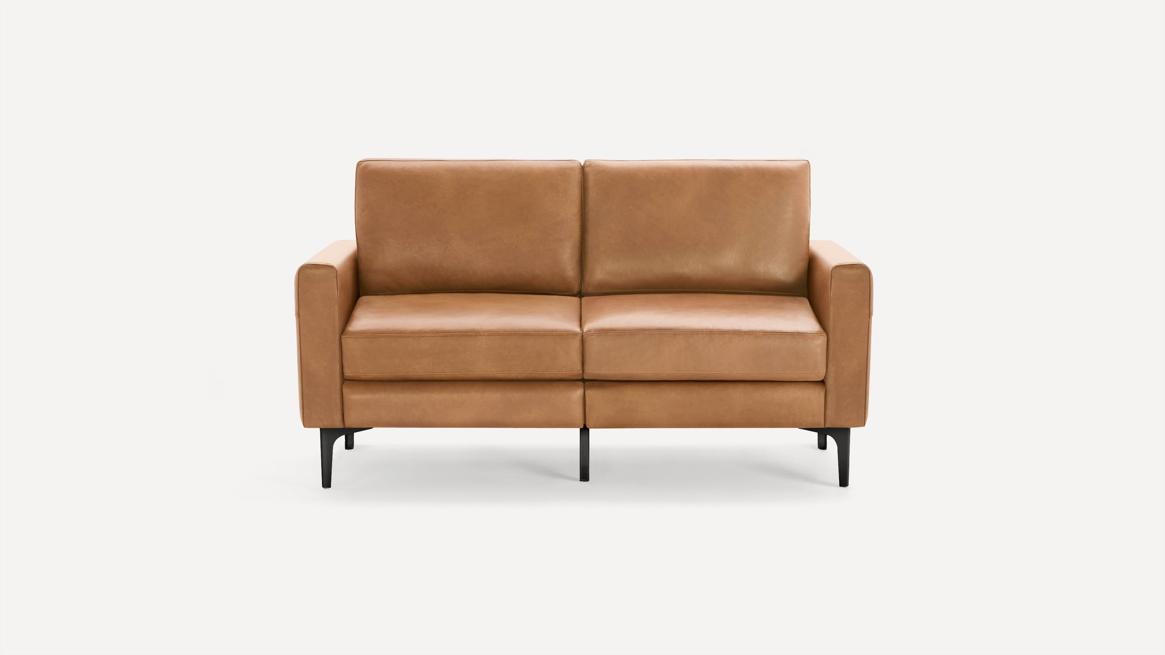 Modern two-seater sofa with tan leather upholstery, straight arms, cushioned seats, and black tapered legs on a white background.