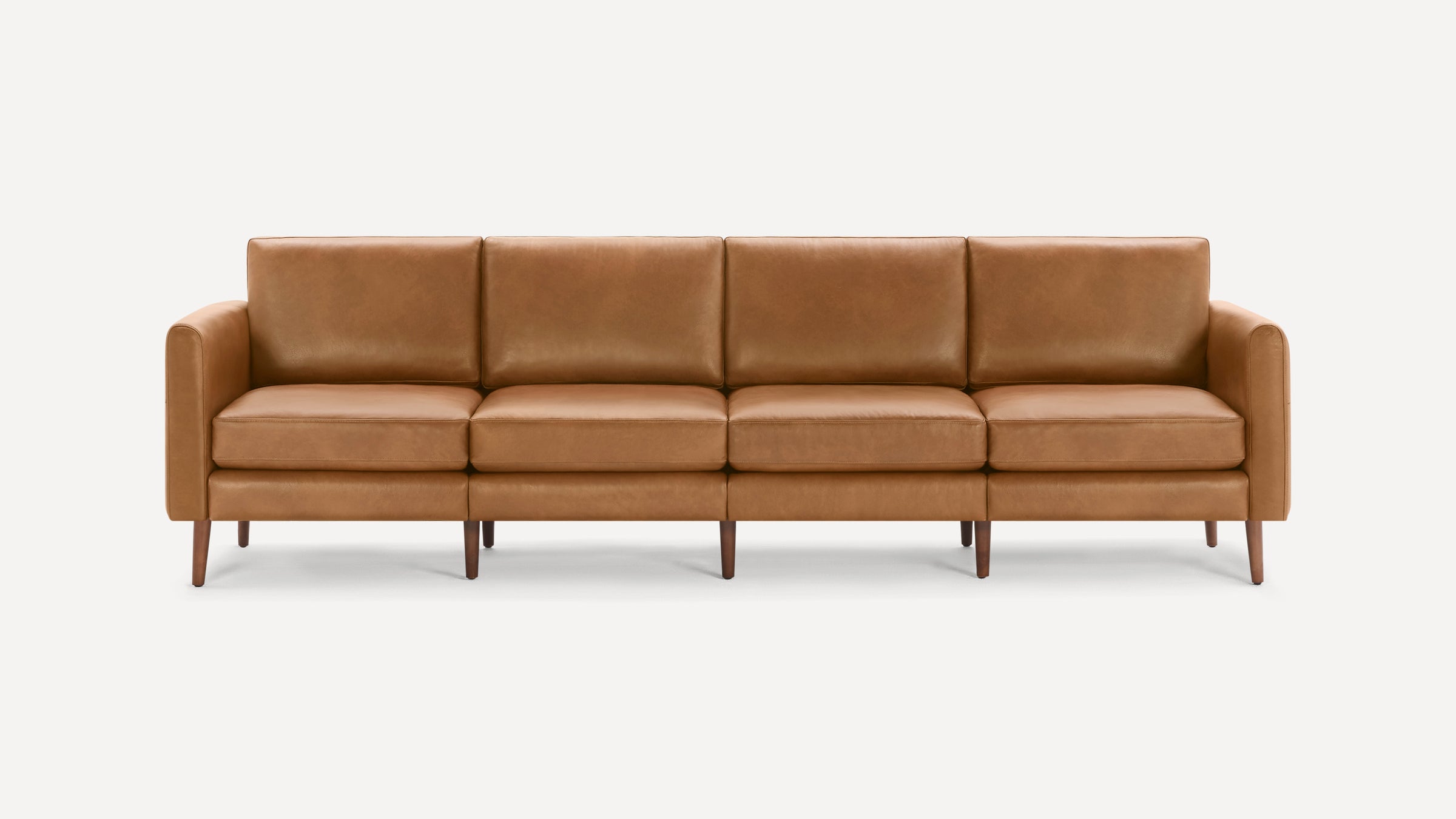 Four-seat mid-century modern sofa with straight arms, brown leather upholstery, and tapered wooden legs on white background.