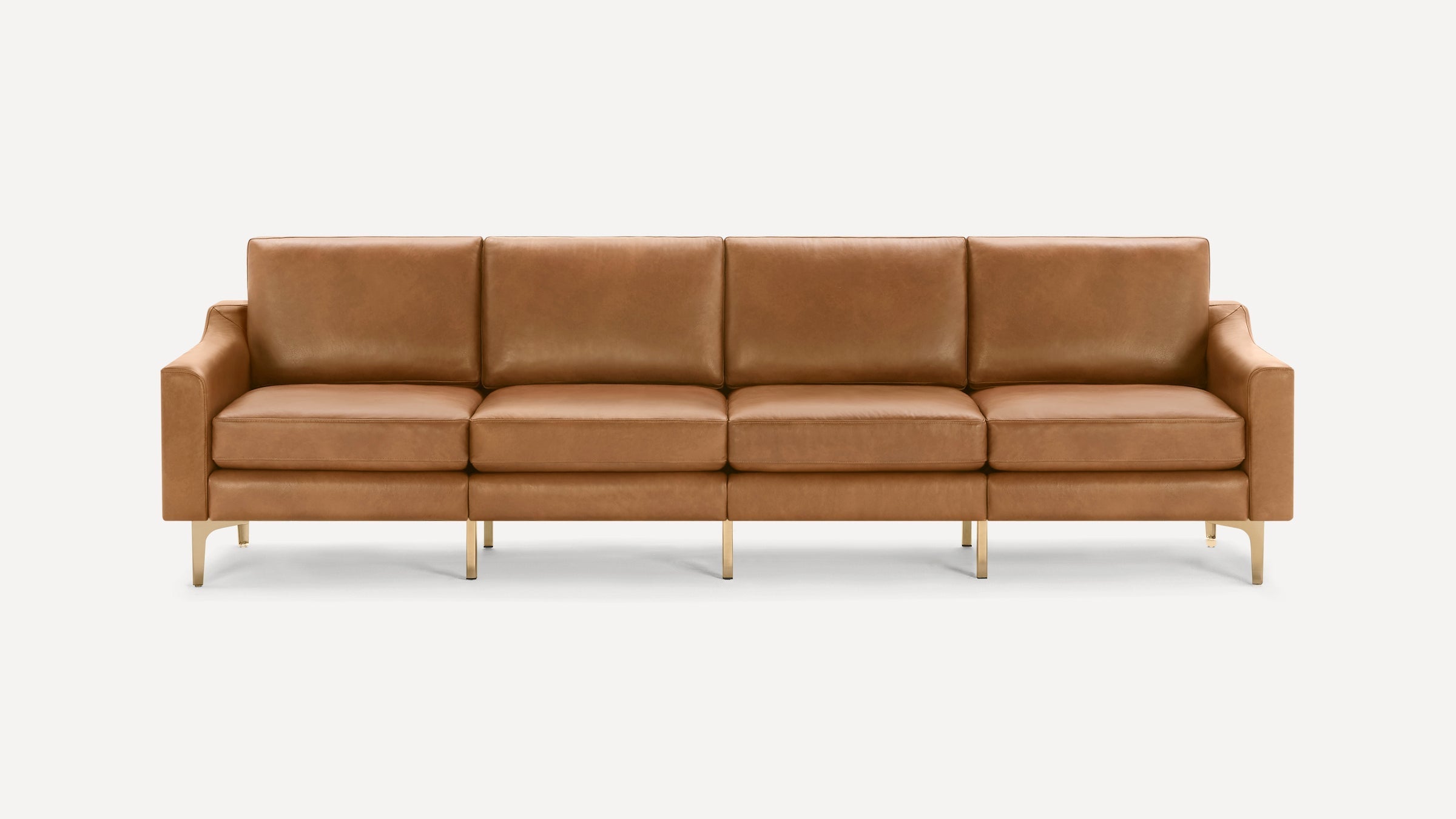 Modern four-seater sofa with clean lines, upholstered in tan leather, featuring slim metallic legs and square armrests.