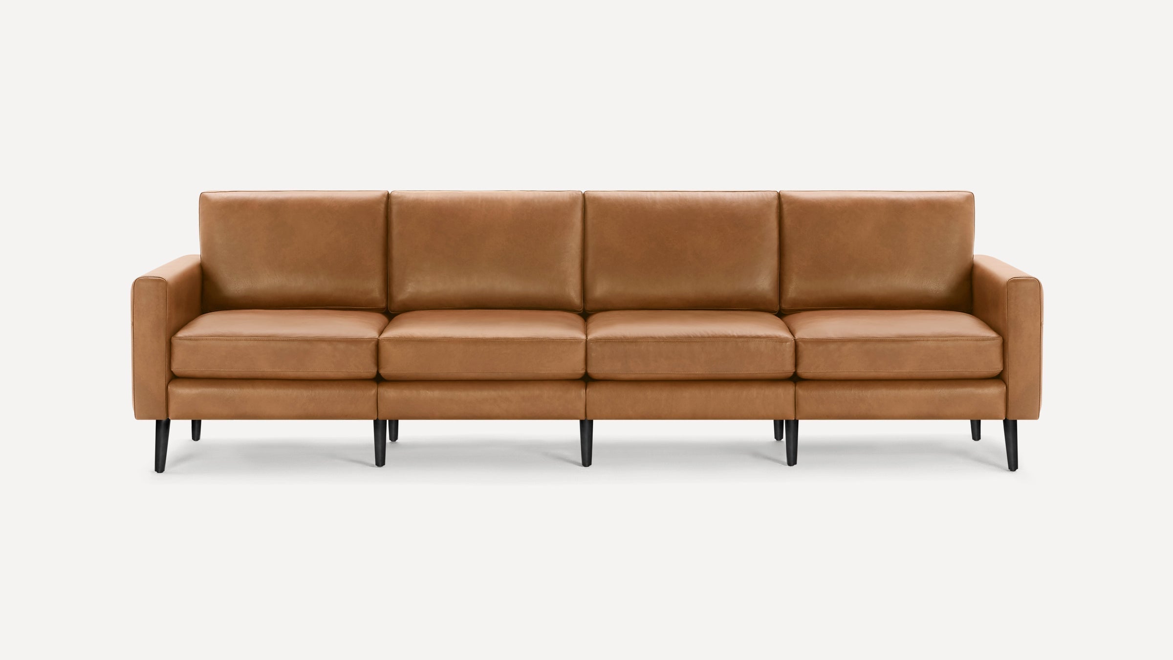 Modern four-seater tan leather sofa with straight armrests and black tapered legs, shown against a white background.