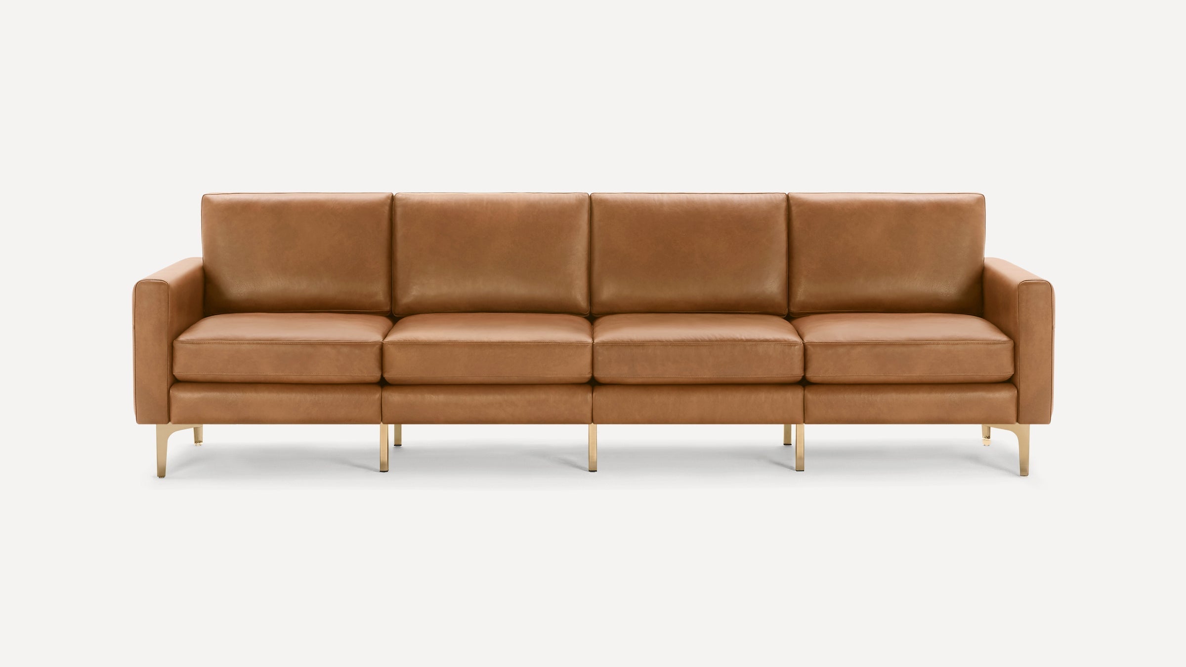 Four-seater modern sofa in light brown leather with clean lines, square armrests, and thin gold metal legs.