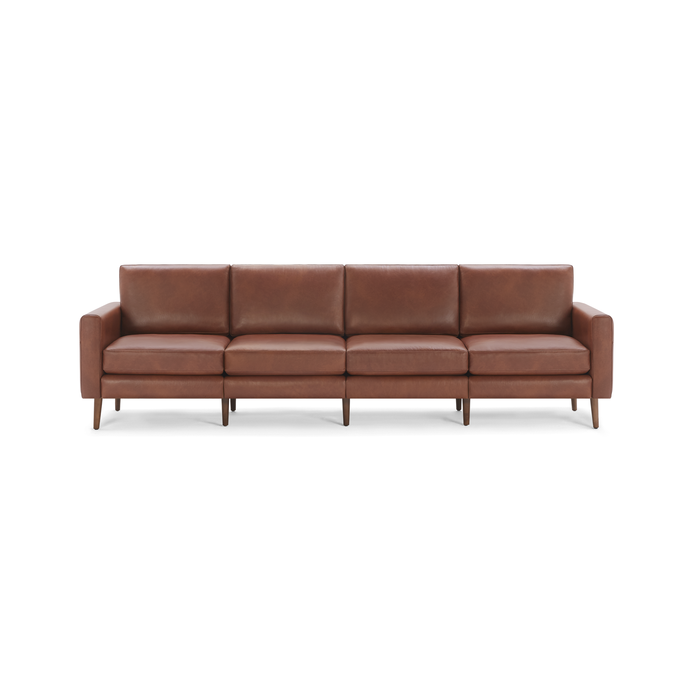 Modern, long brown leather sofa with four spacious seats, clean lines, and wooden legs isolated on a white background.