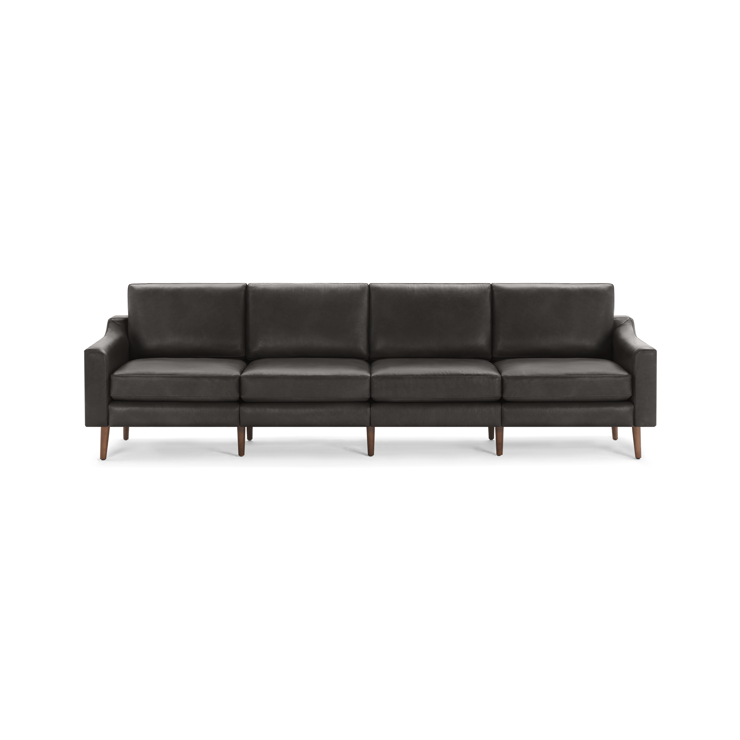 Long dark gray leather sofa with four cushions, sleek square arms, and wooden tapered legs on black background.