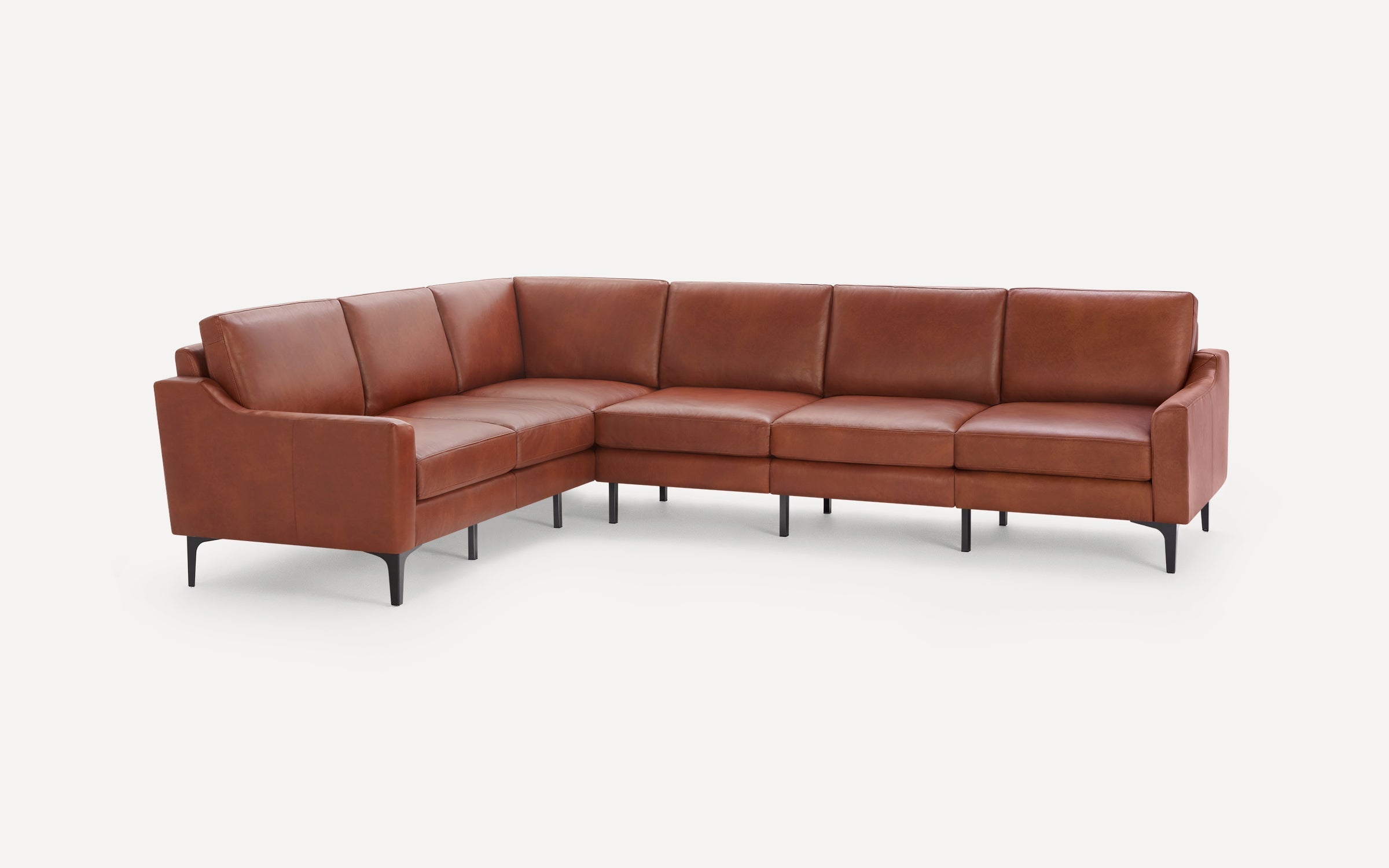 Modern L-shaped sectional sofa with rust brown leather upholstery and black tapered metal legs on white background.