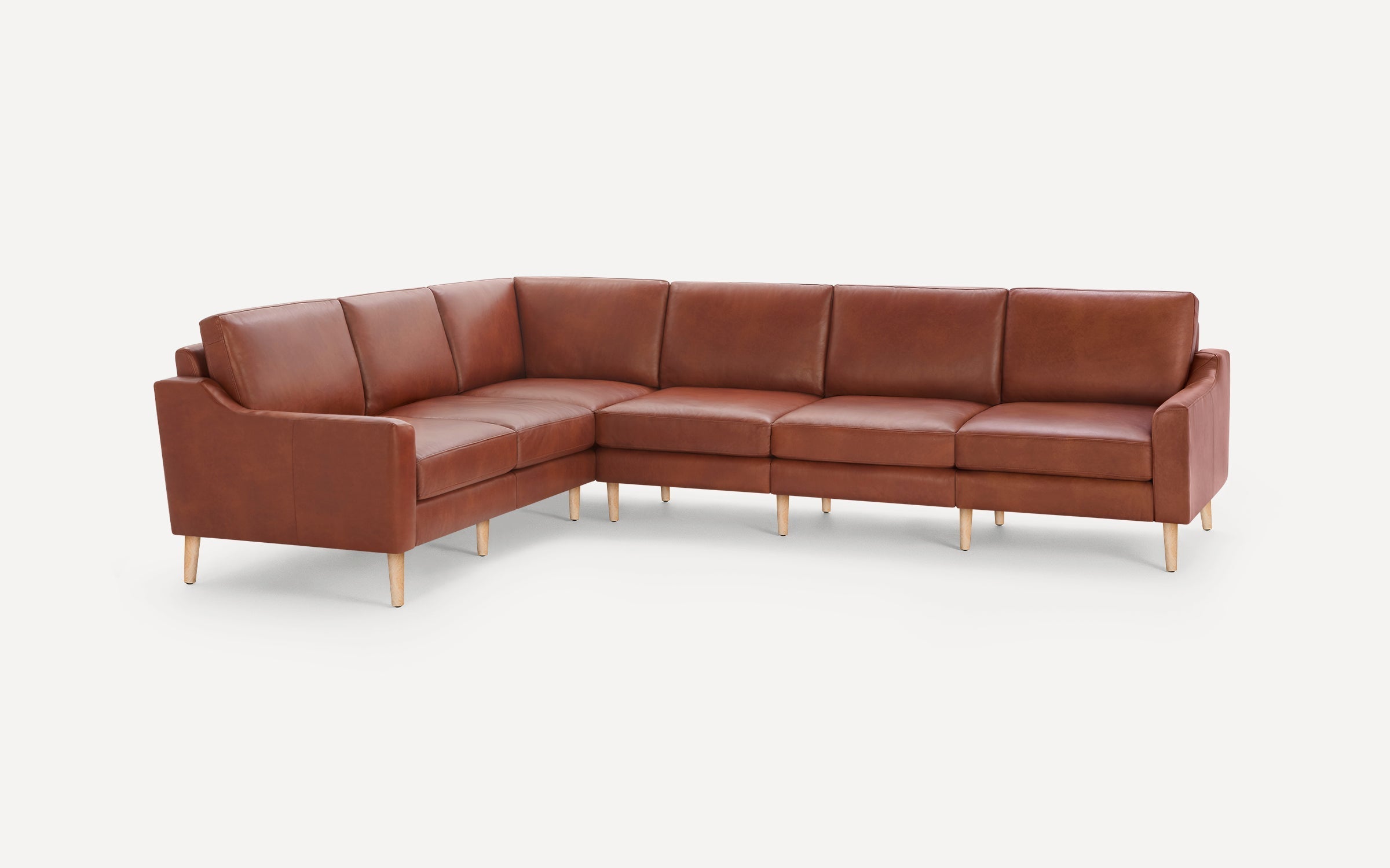 Brown leather L-shaped sectional sofa with wooden legs, featuring clean lines and modern design on a white background.