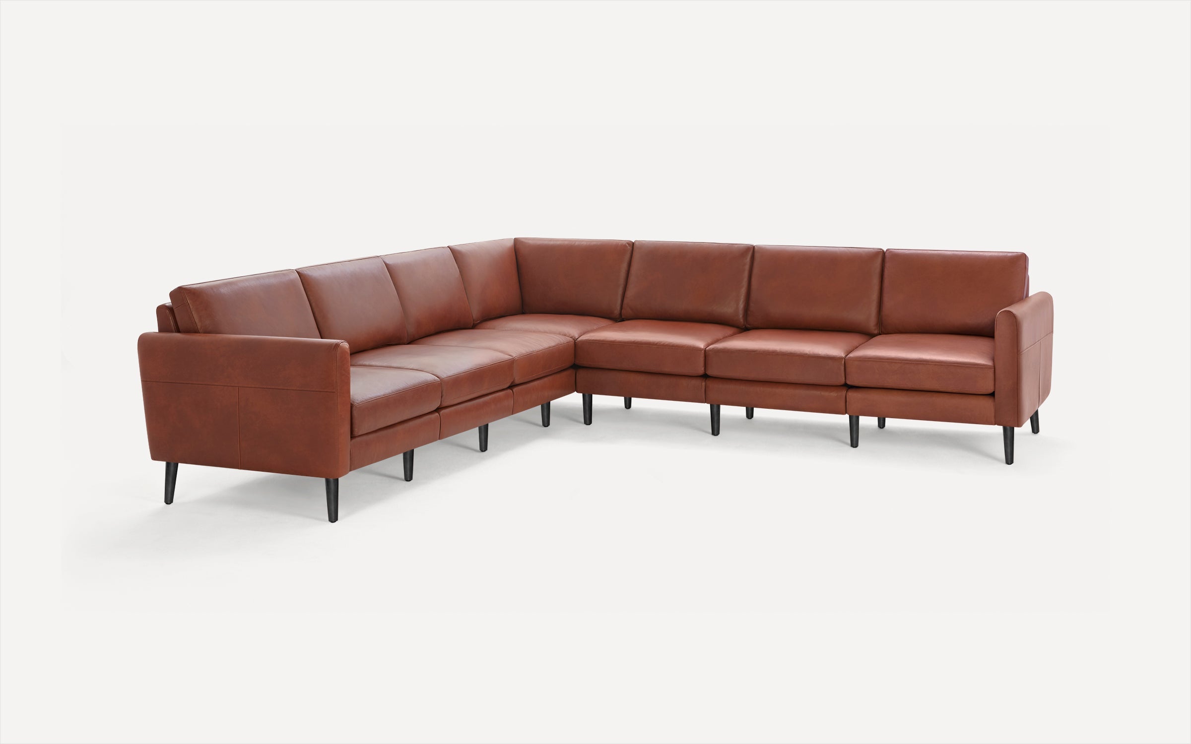 L-shaped sectional sofa in brown leather with black tapered legs and cushioned seats and backs.