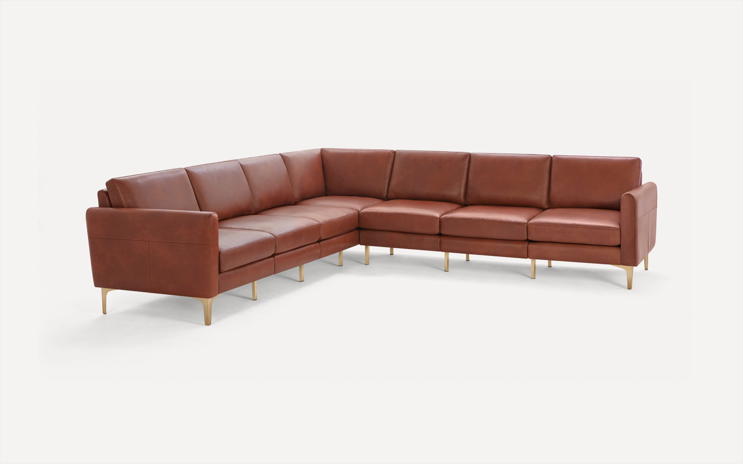 Brown leather sectional sofa with clean lines and gold-toned legs on a white background.