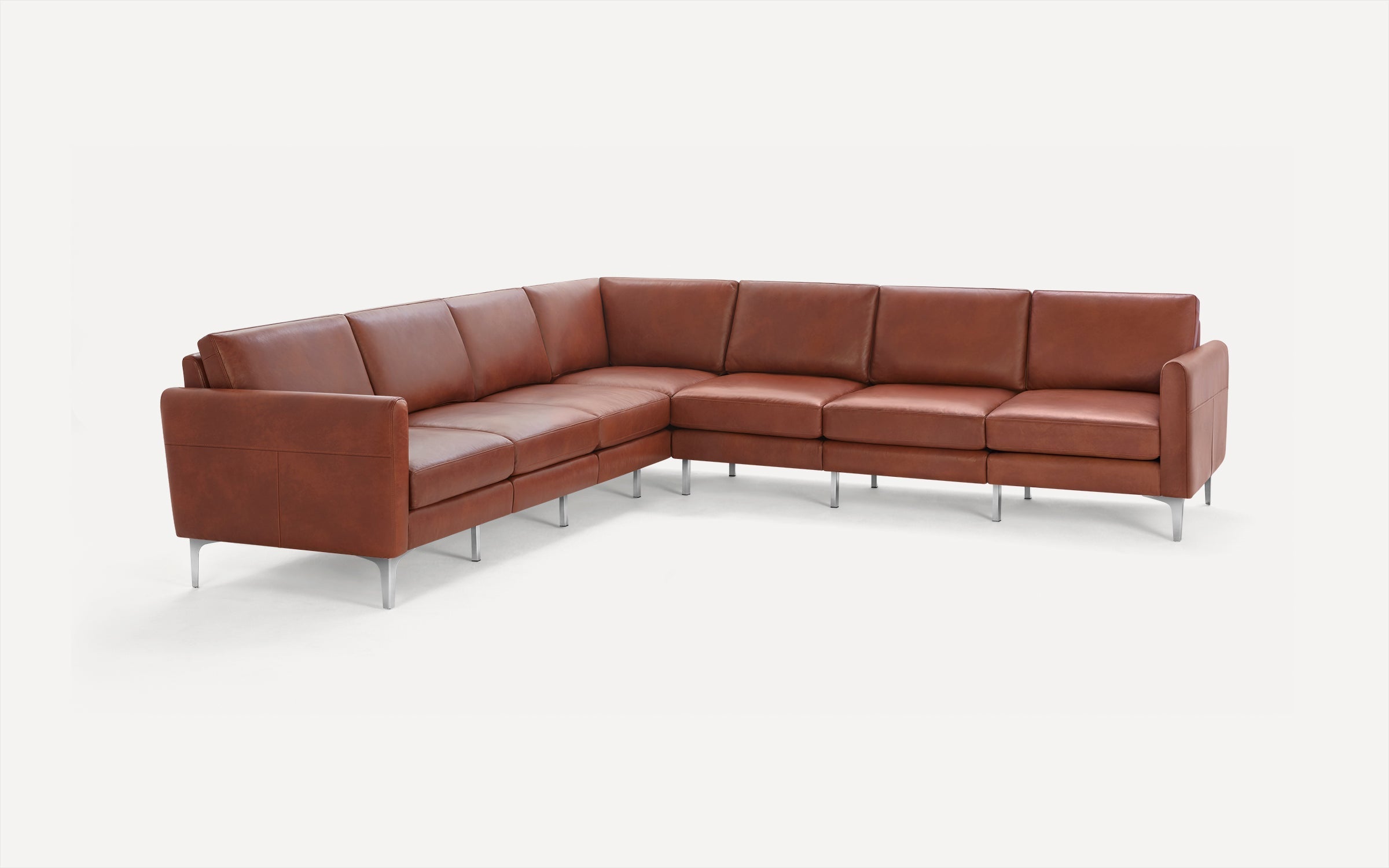L-shaped sectional sofa with smooth brown leather upholstery and slim silver metal legs on a white background.