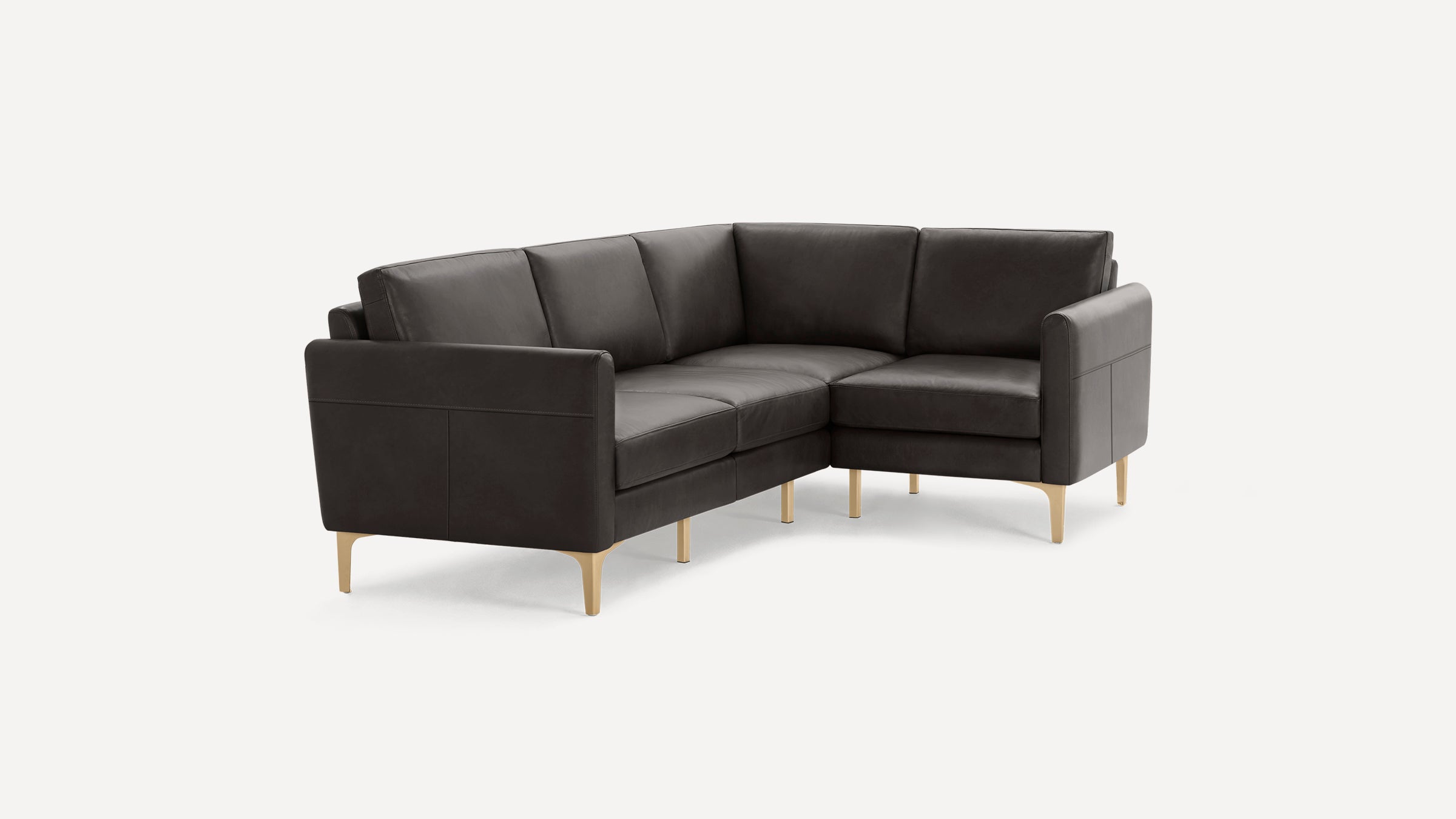 Dark brown leather L-shaped sectional sofa with slim gold metal legs on white background.