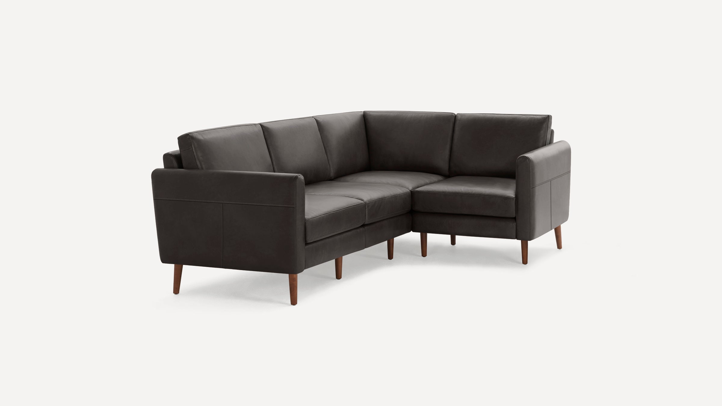 Dark brown leather L-shaped sectional sofa with wooden tapered legs and cushioned seats and backrests.
