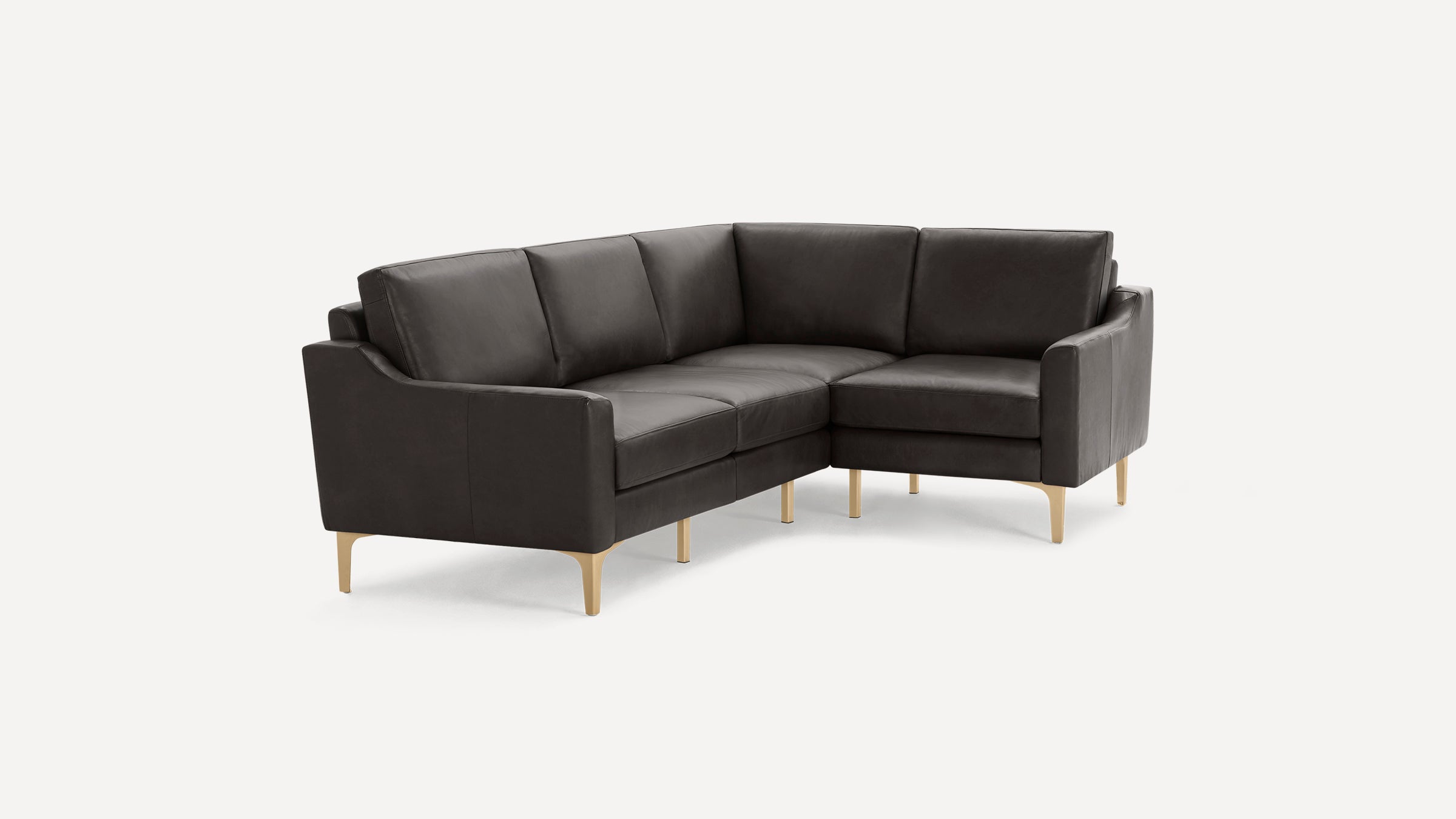 Modern dark gray leather L-shaped sectional sofa with slim gold metal legs, cushioned seats, and backrests on a white background.