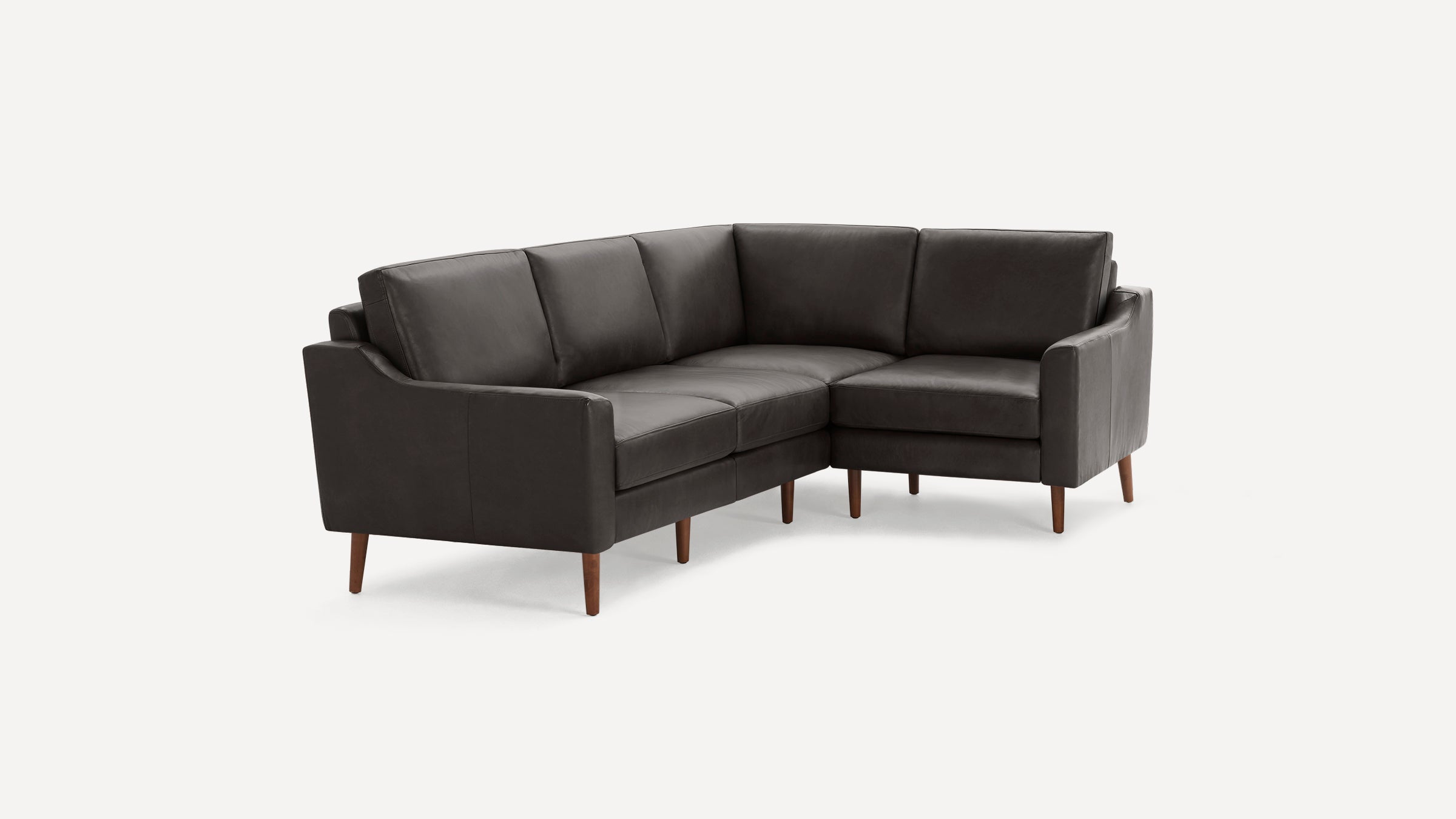 Dark gray leather L-shaped sectional sofa with clean lines and wooden tapered legs on white background.