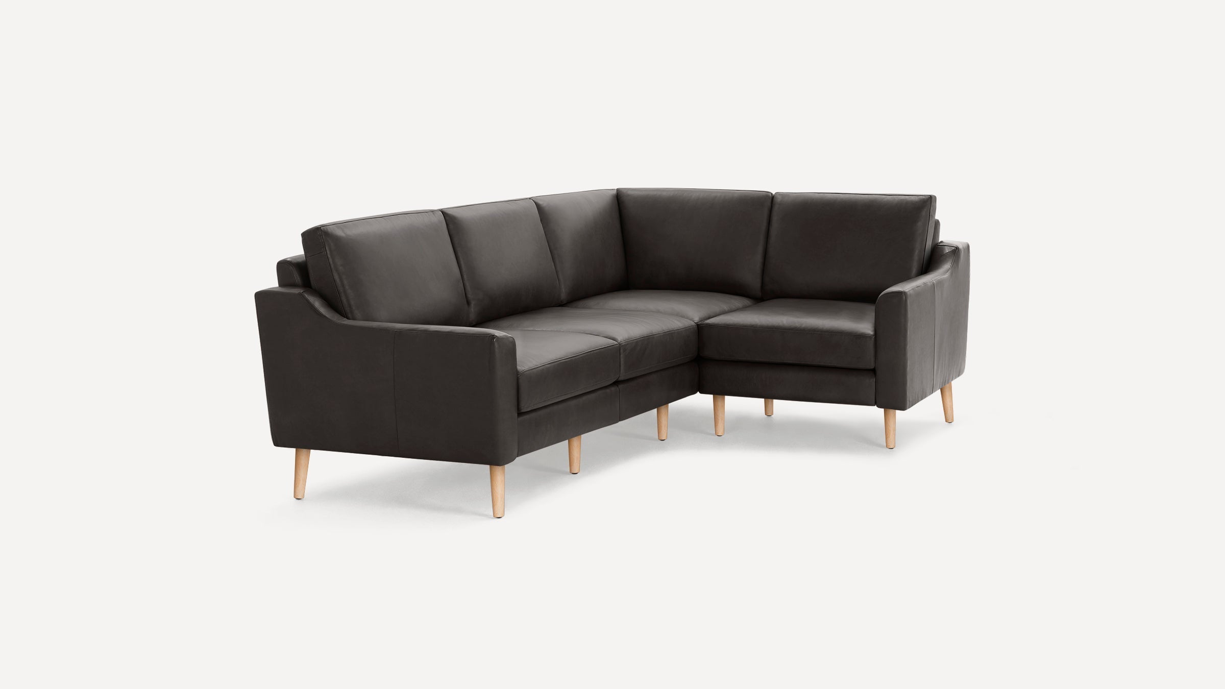 Dark gray leather L-shaped sectional sofa with wooden legs, clean modern design, and cushioned seats and backrests.
