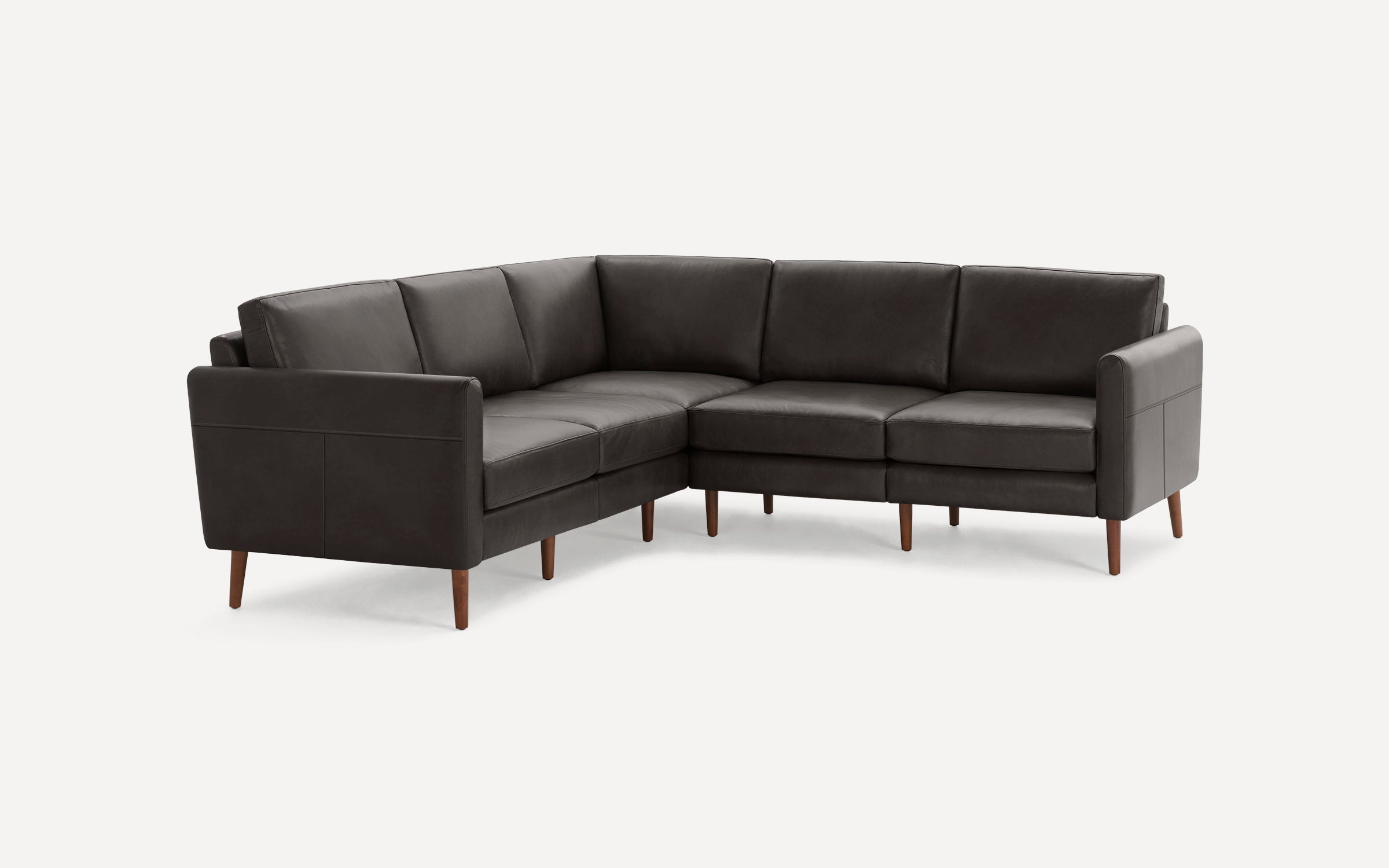 Dark gray leather L-shaped sectional sofa with wooden legs, clean lines, and modern design against a plain white background.