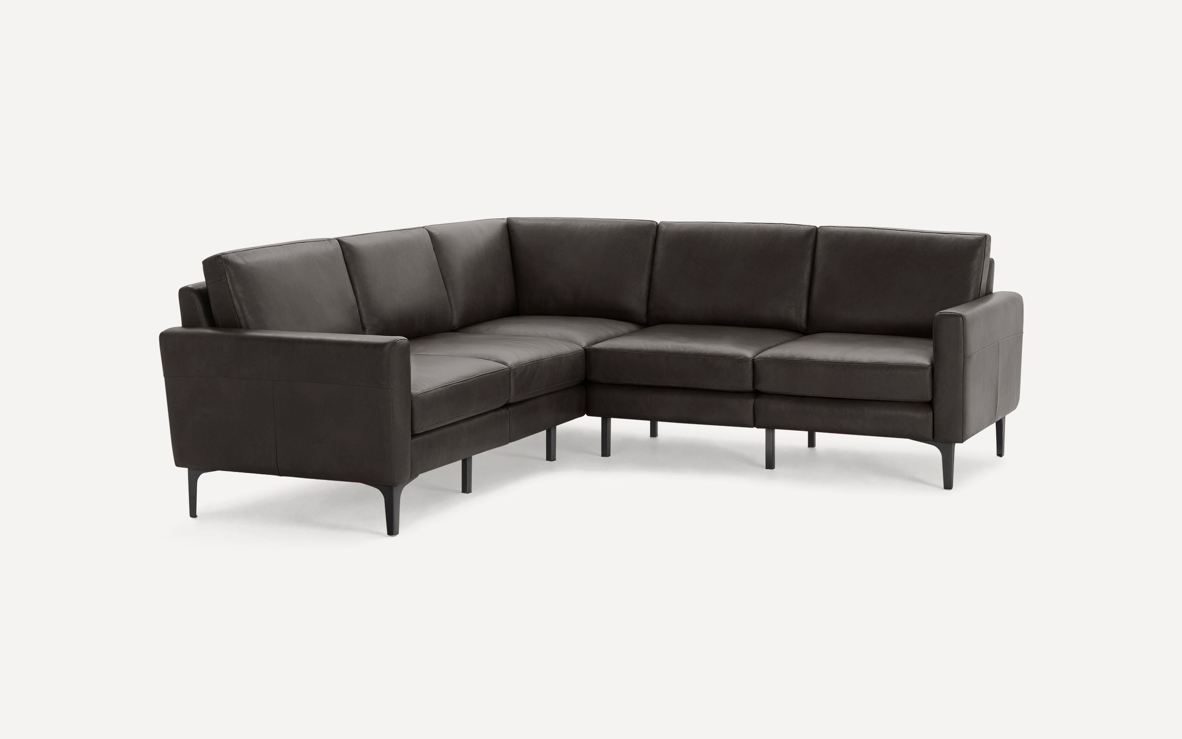 Modern dark gray leather L-shaped sectional sofa with thin black legs and clean, minimalist design on white background.