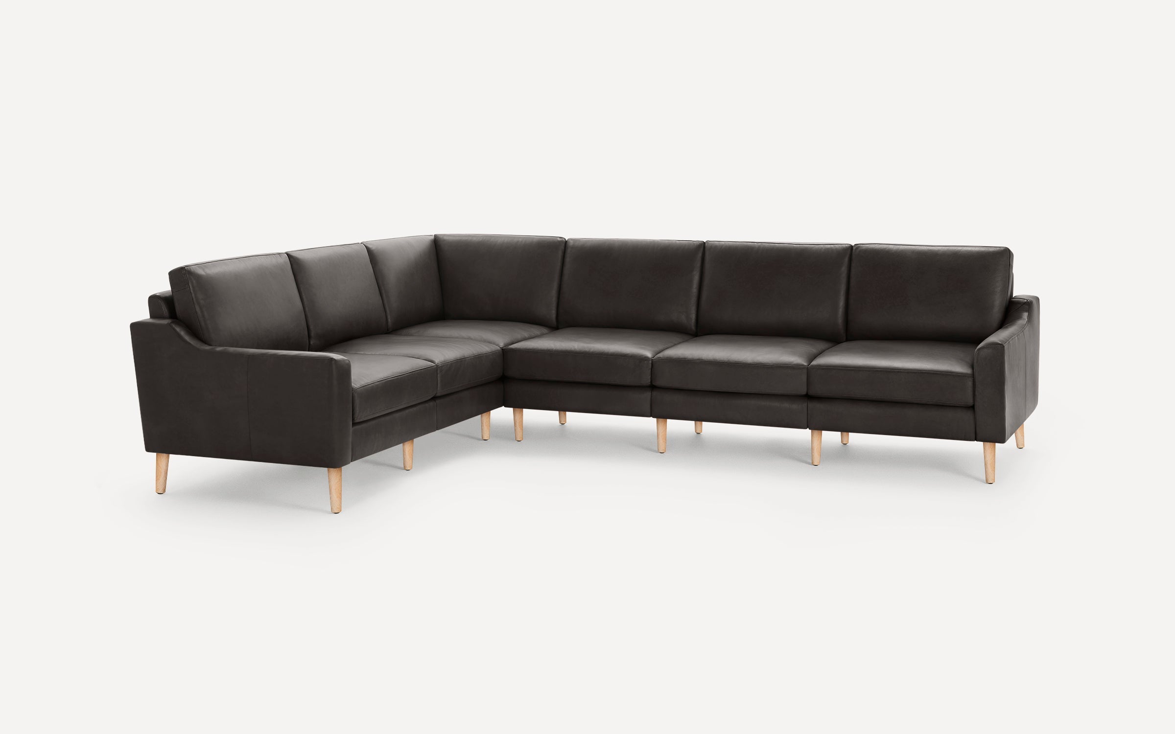 Modern dark gray leather sectional sofa with clean lines and light wooden legs, designed for corner seating.