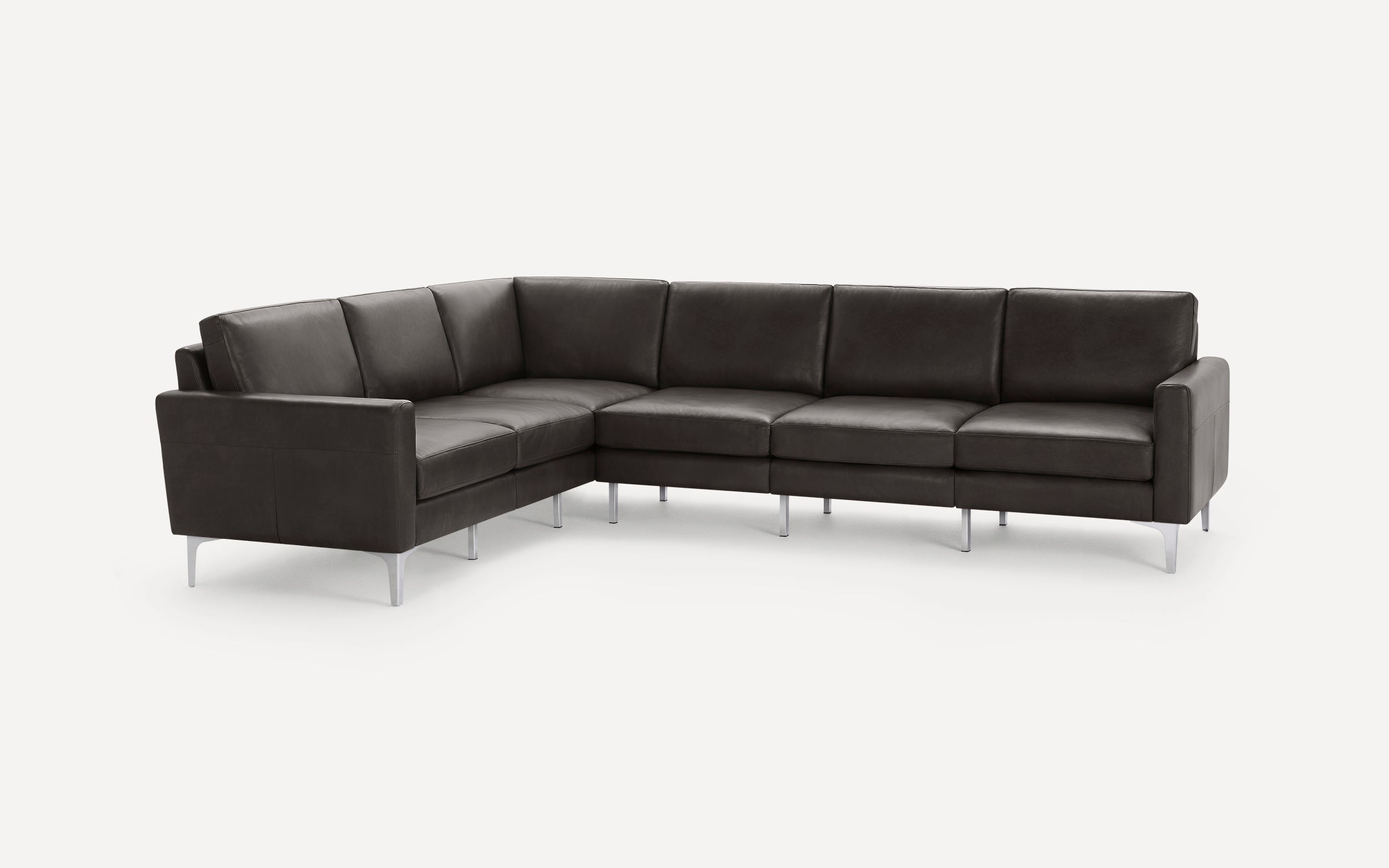 Dark gray L-shaped sectional sofa with sleek metal legs and modern minimalist design on a white background.