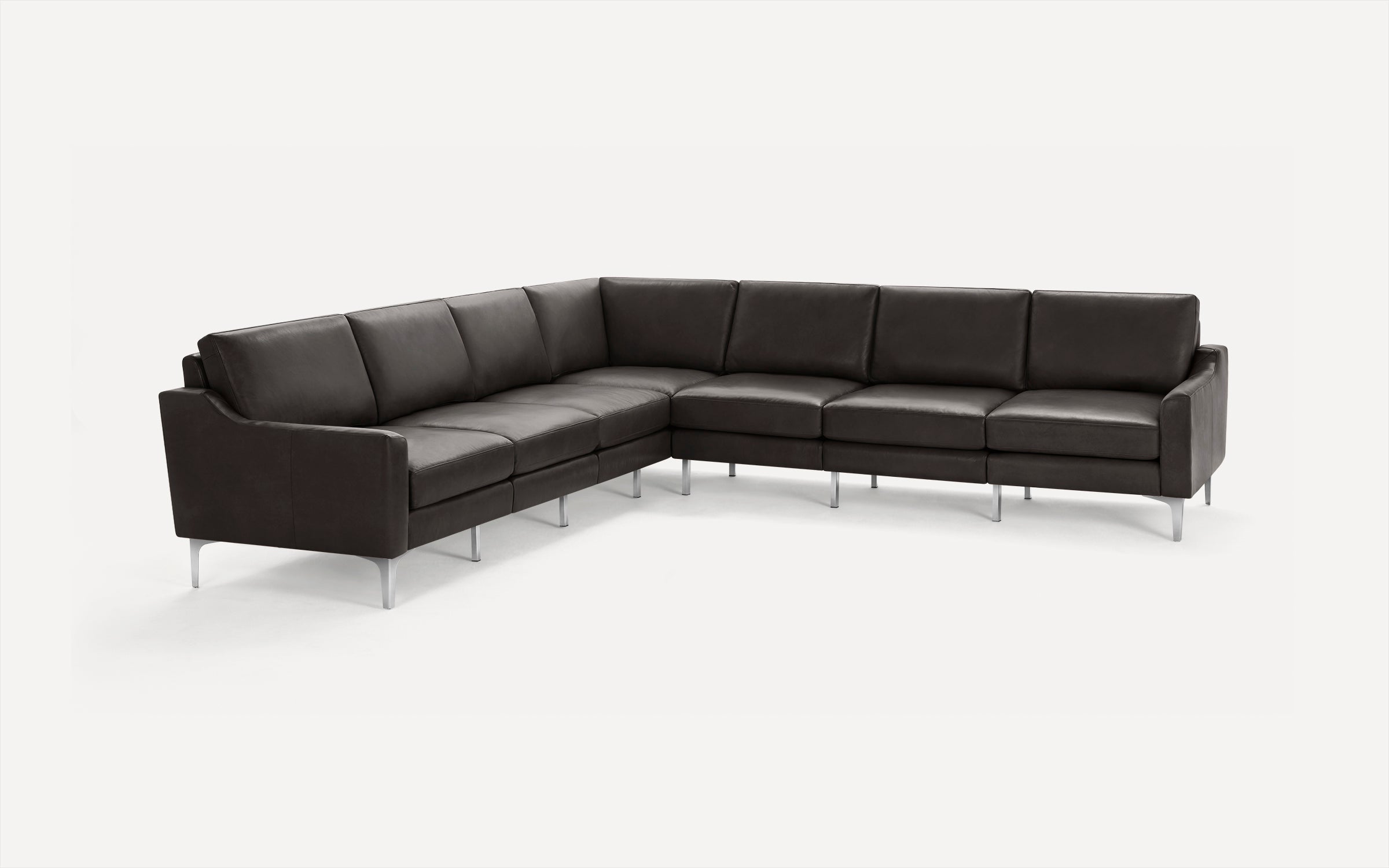 Large modern L-shaped sectional sofa with dark brown leather upholstery and slender metal legs on white background.