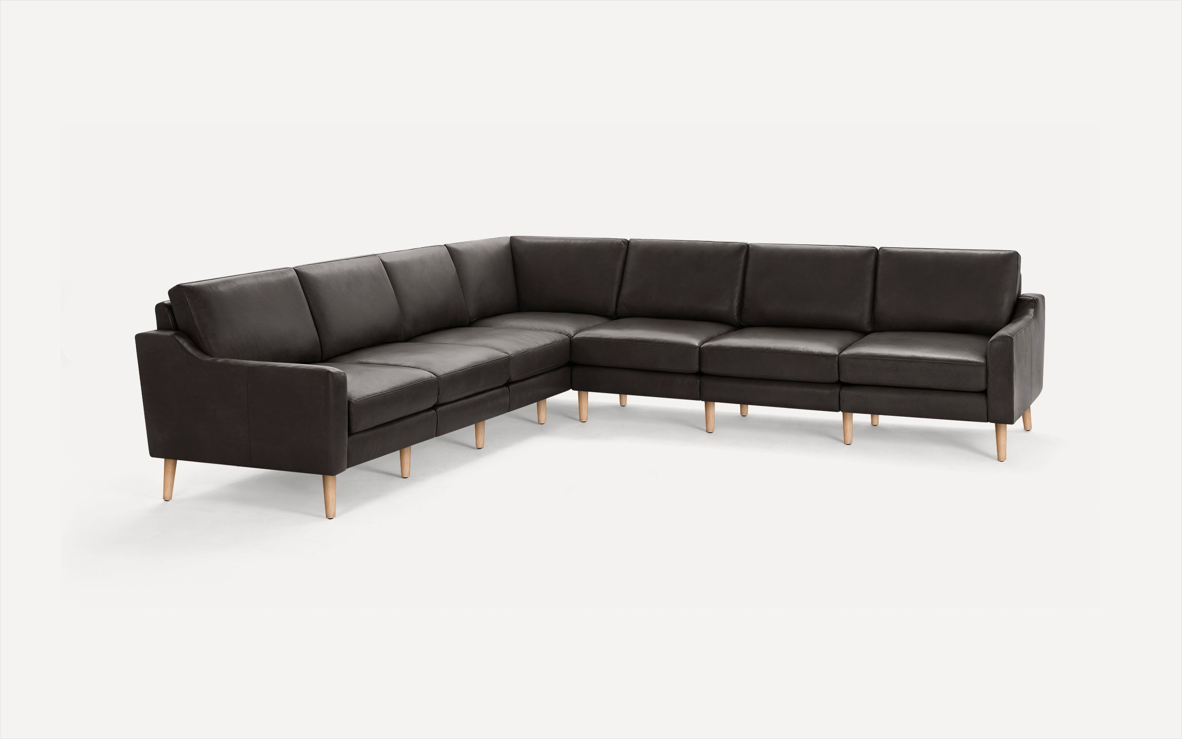 Dark brown leather L-shaped sectional sofa with wooden legs, featuring clean lines and cushioned seats and backrests.