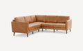 Mid-century modern L-shaped sectional sofa in tan leather with clean lines and wooden tapered legs.