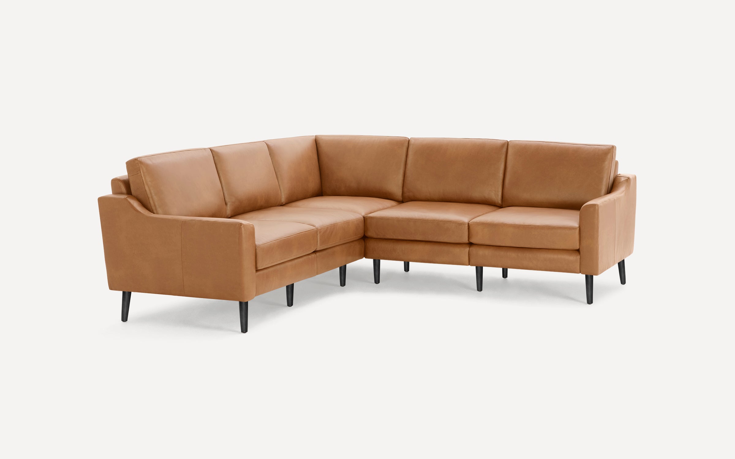 Modern L-shaped sectional sofa in tan leather with slim black legs, featuring clean lines and cushioned seating.
