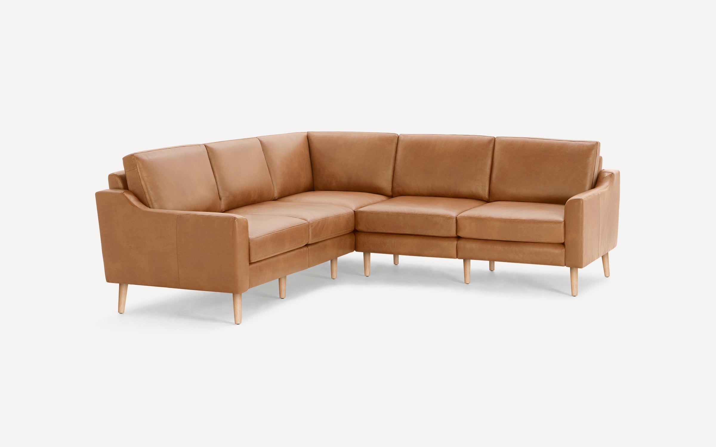 L-shaped brown leather sectional sofa with wooden legs, featuring clean lines and cushioned seats and backs.
