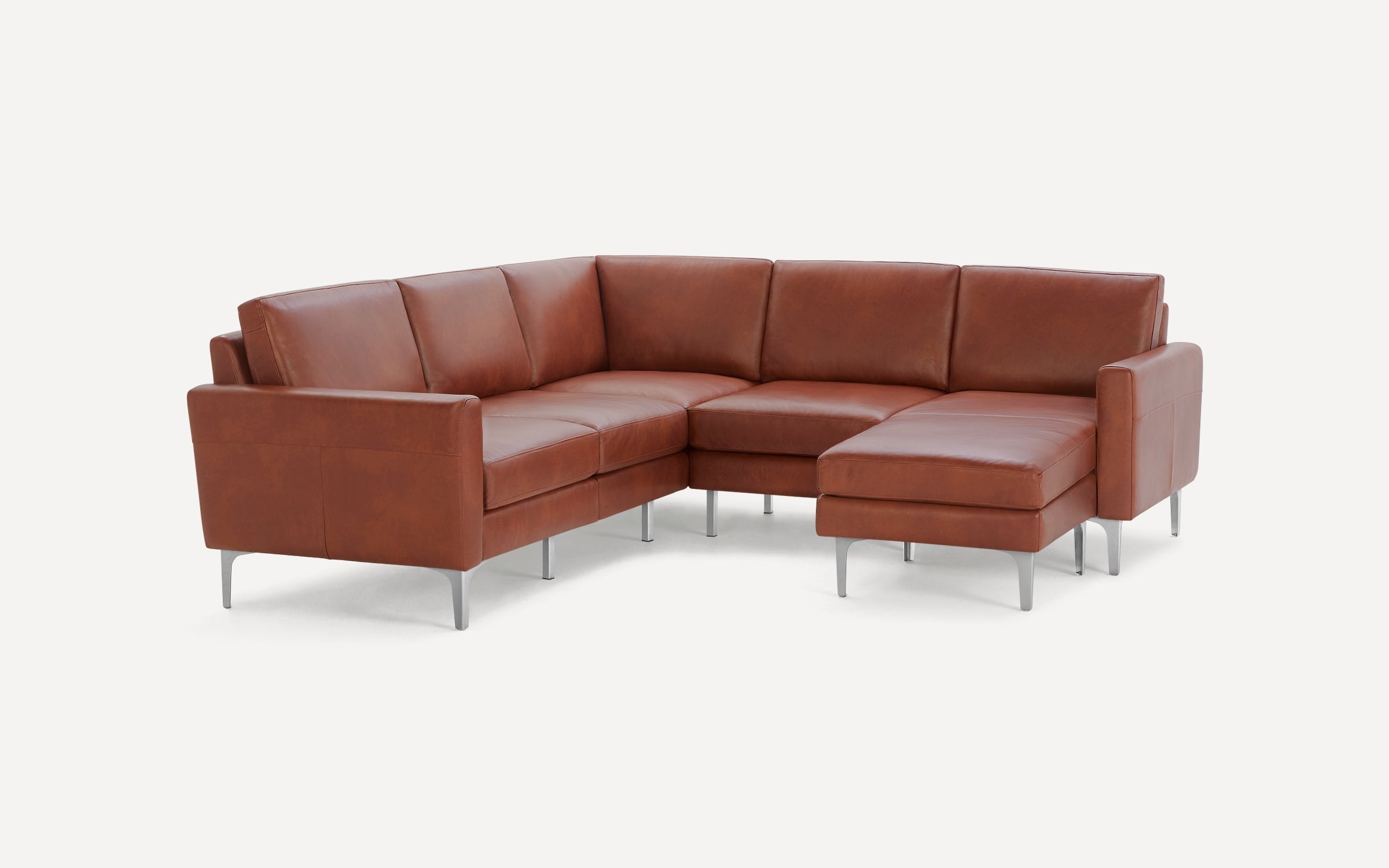 Modern mid-century style brown leather sectional sofa with metal legs, featuring a chaise lounge on the right side.
