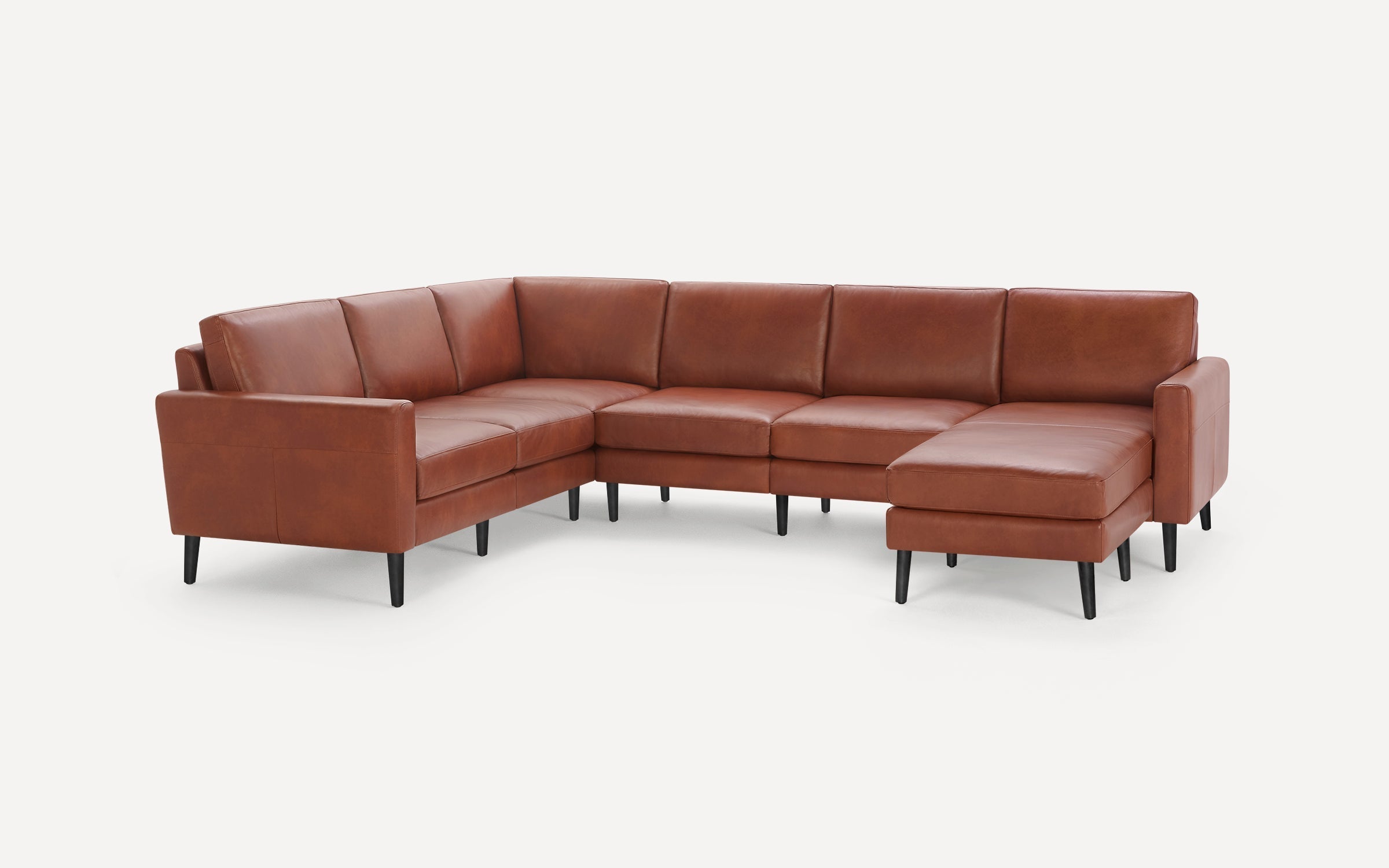 Modern brown leather sectional sofa with black tapered legs, right-facing chaise, and clean lines on a white background.