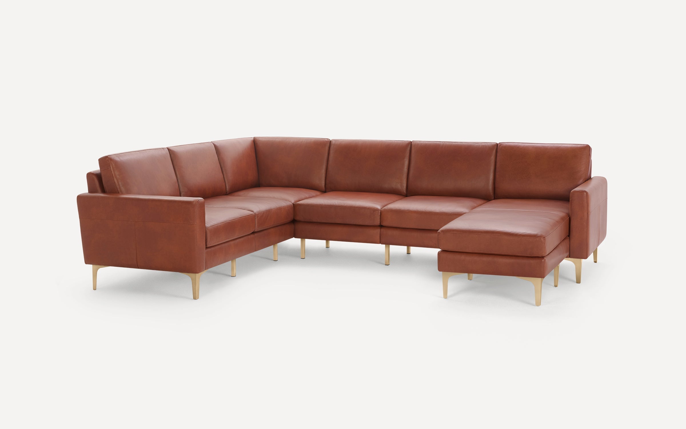 Modern brown leather sectional sofa with metal legs, featuring an L-shape design and cushioned seats and backs.