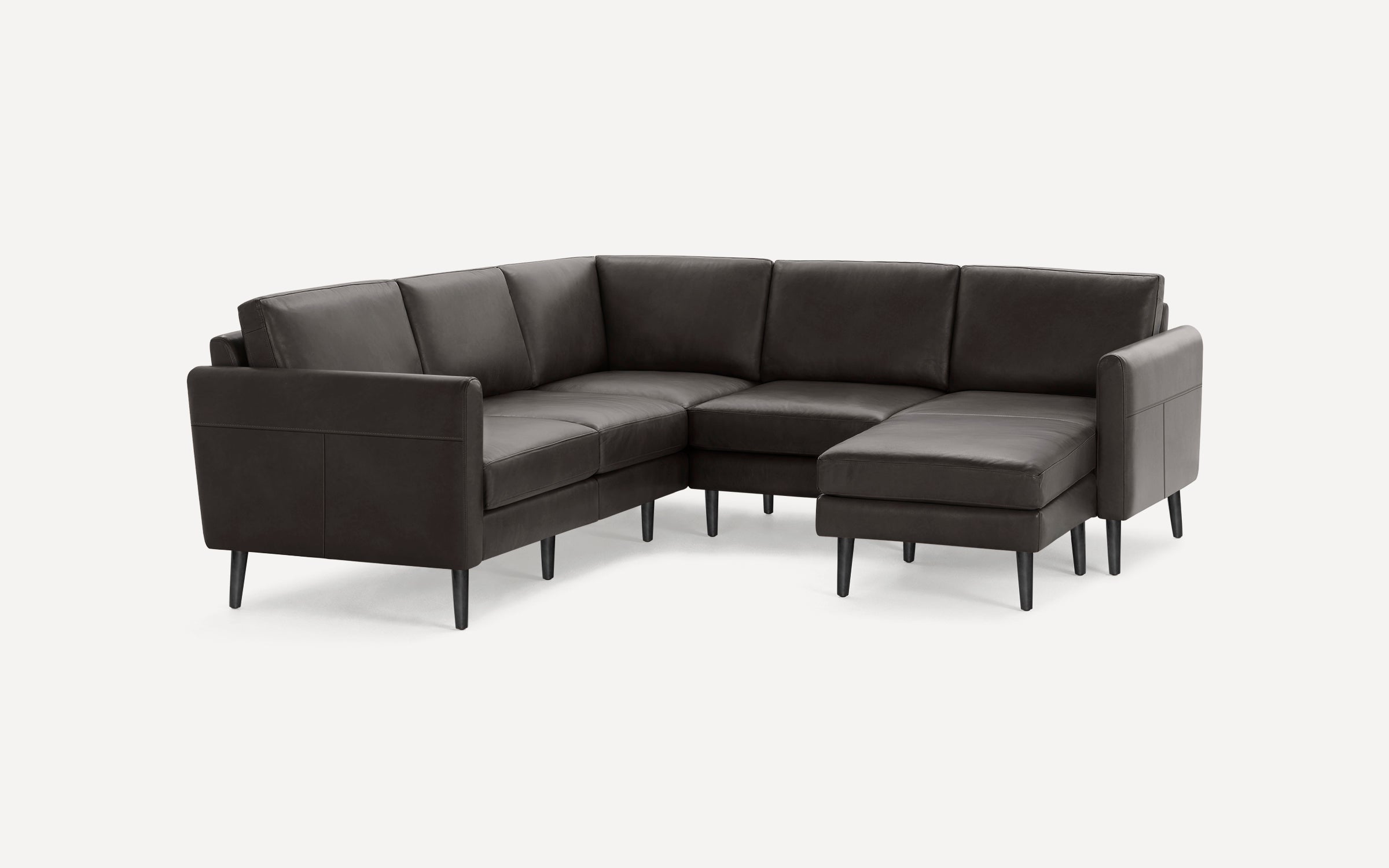 Dark brown leather sectional sofa with clean lines, tapered black legs, and an extended chaise lounge on the right side.