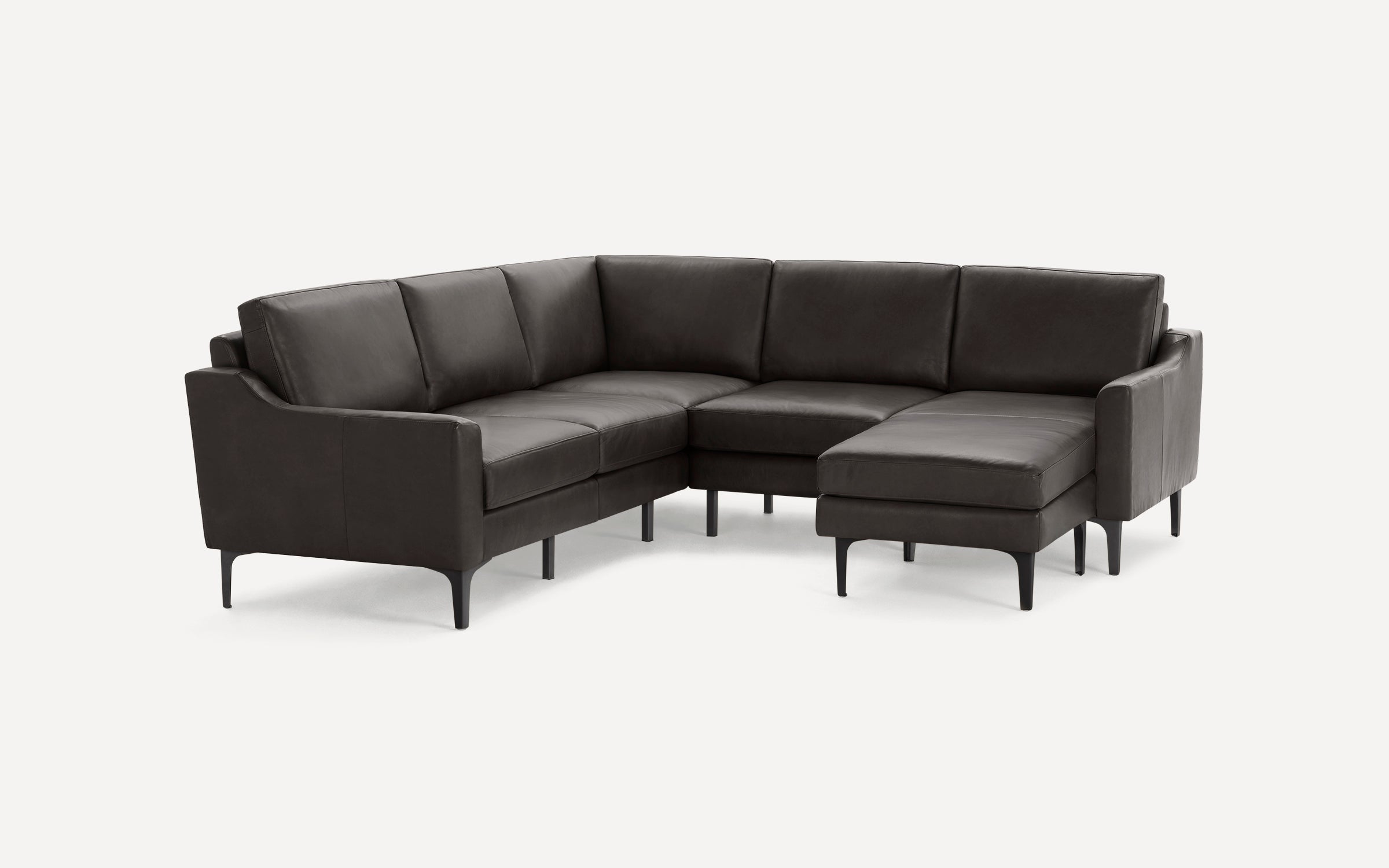 Dark brown leather sectional sofa with modern design, straight arms, and slim black legs on a white background.
