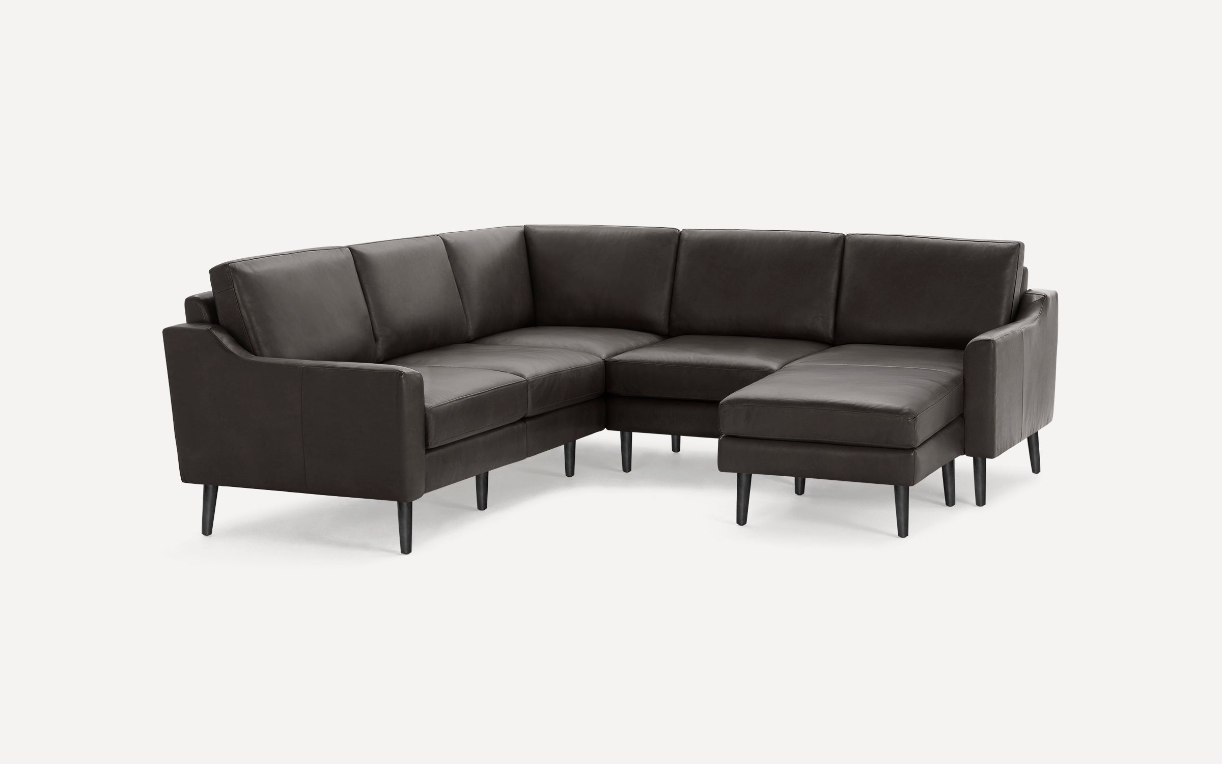 Modern dark gray leather sectional sofa with clean lines, cushioned seats, backrests, and tapered black legs.