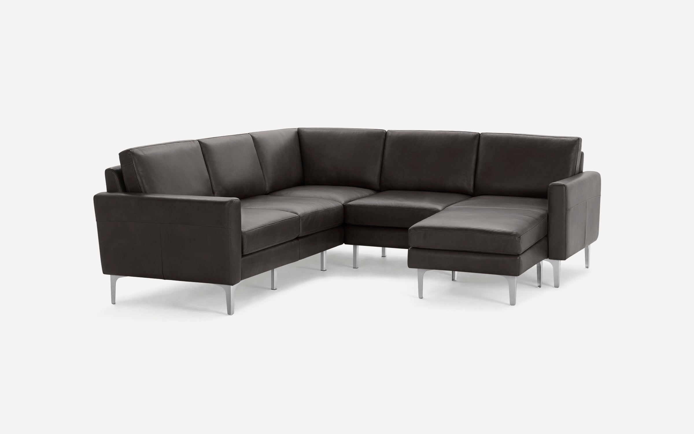 Dark gray leather sectional sofa with sleek metal legs, featuring an L-shaped design and cushioned seating.