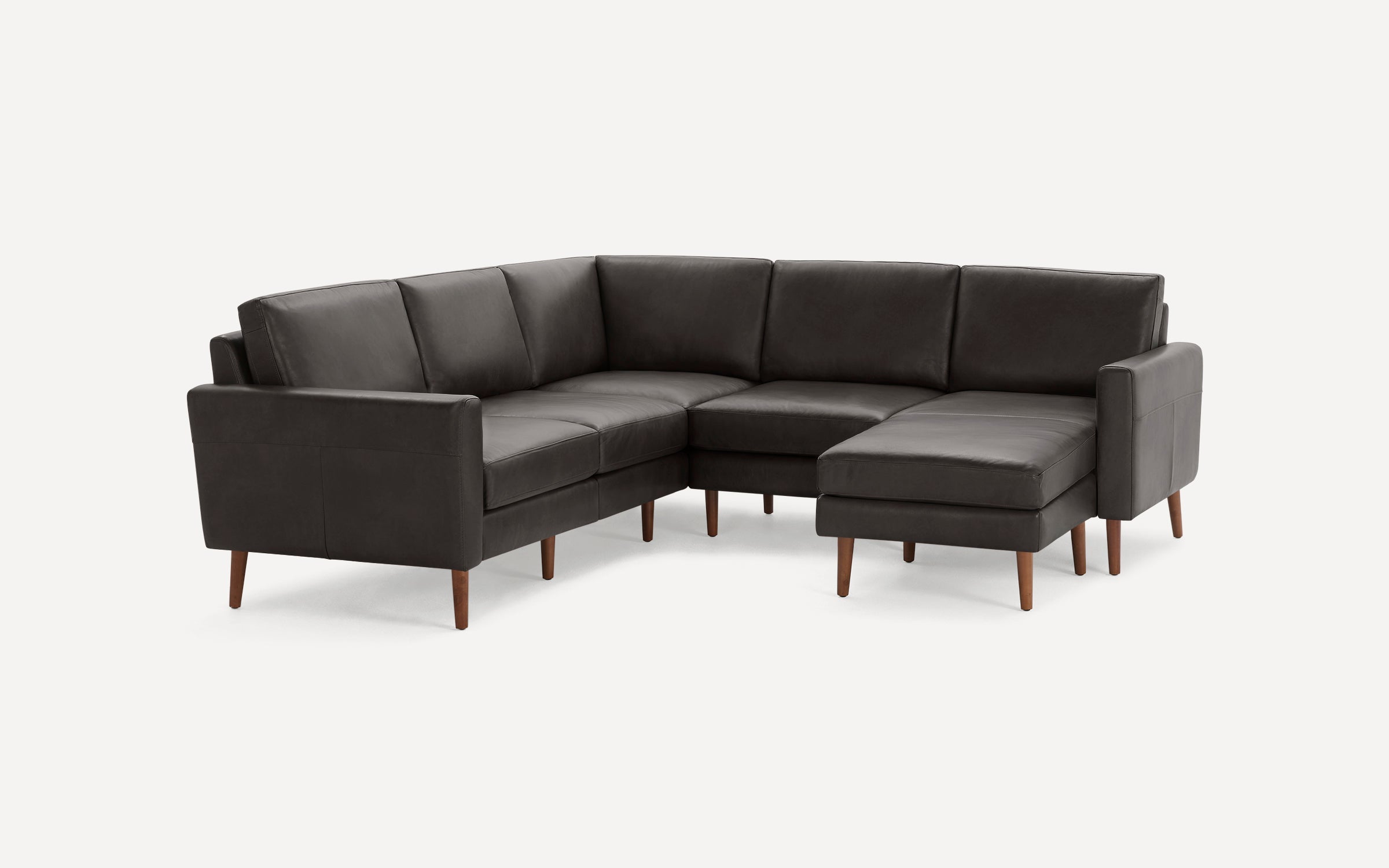 Dark gray leather sectional sofa with wooden legs, featuring an L-shaped design and clean, modern lines.