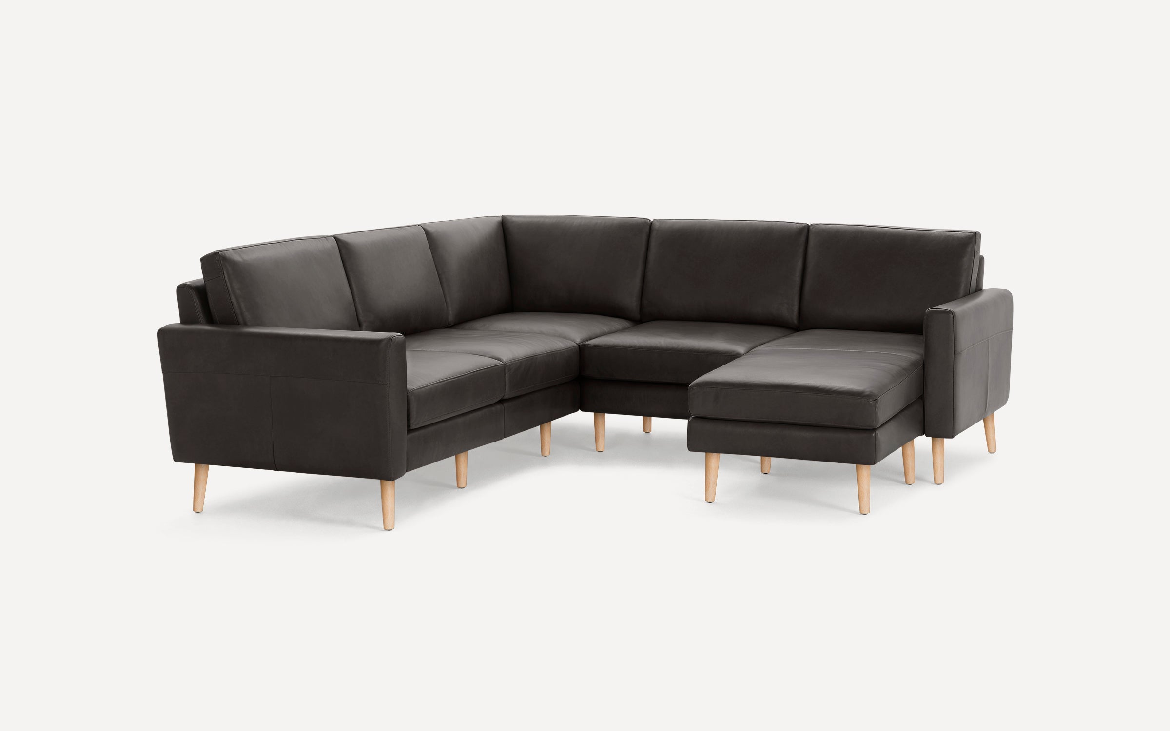 Dark gray L-shaped sectional sofa with wooden legs, featuring cushioned seats and backrests for comfortable seating.