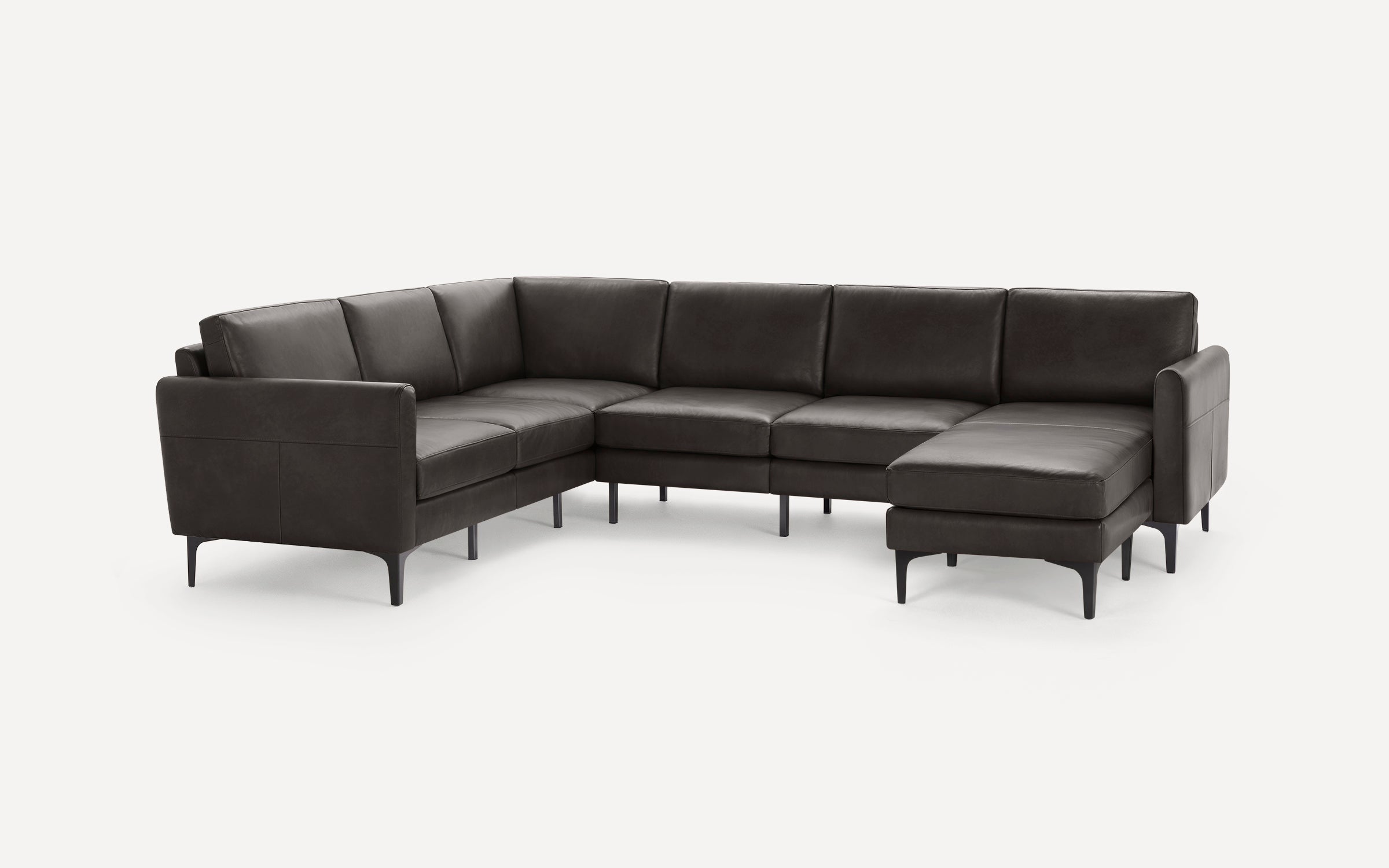 Modern dark brown leather sectional sofa with clean lines, metal legs, and a chaise lounge on the right side.