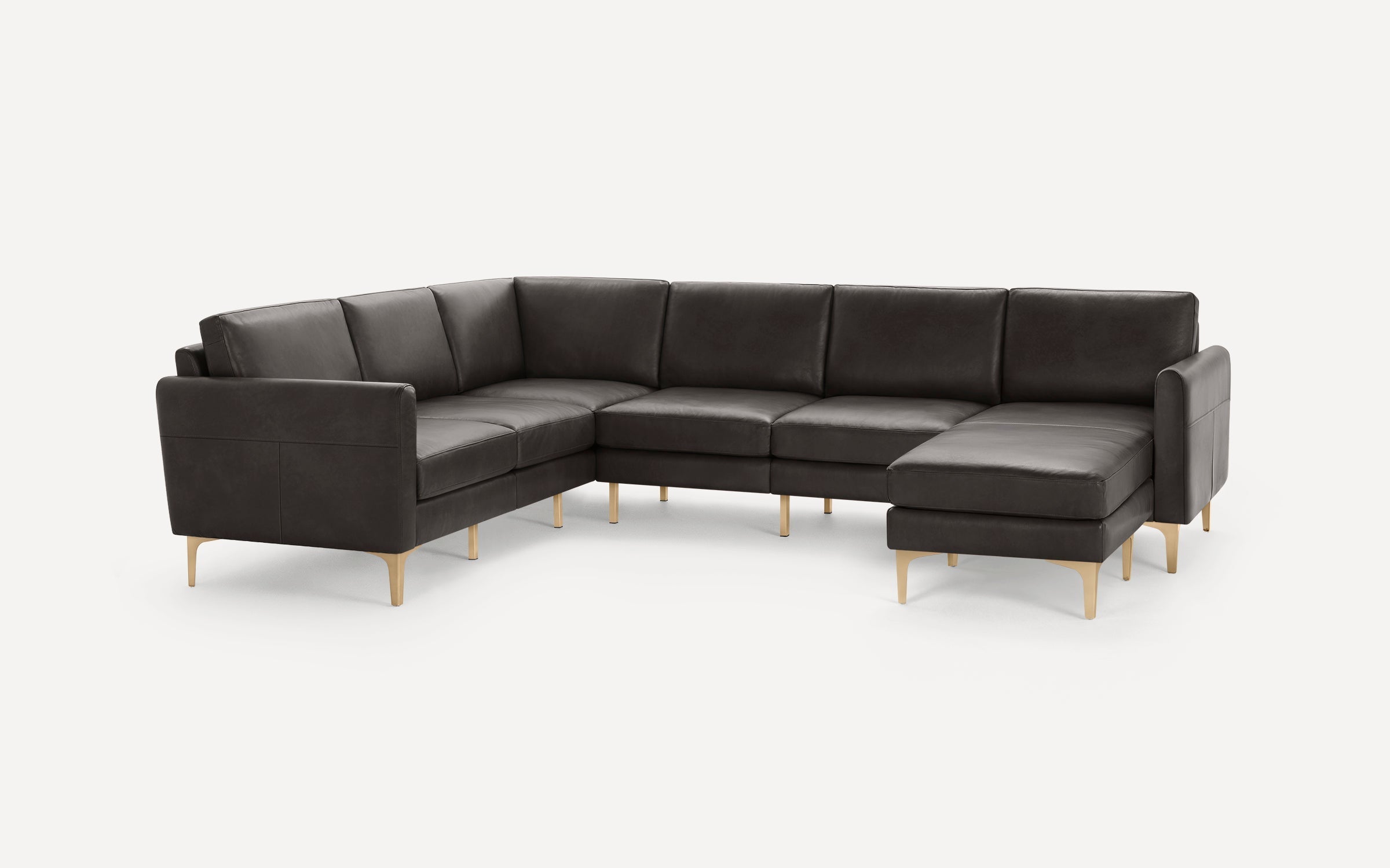 Modern dark gray L-shaped sectional sofa with sleek metal legs and plush cushions, designed for spacious living rooms.