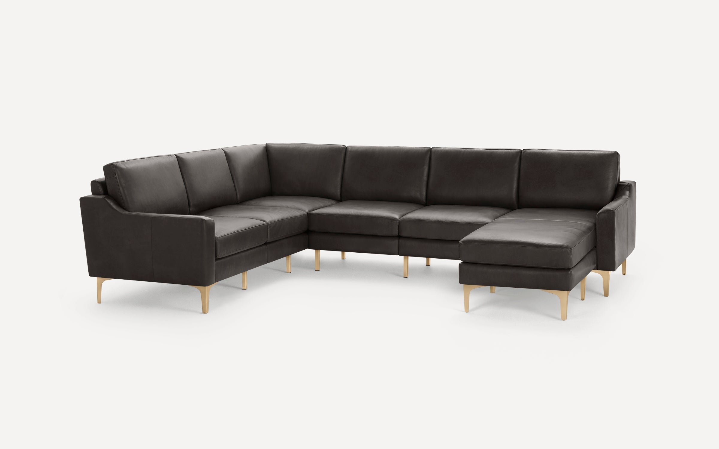 Modern dark gray leather sectional sofa with clean lines, slim armrests, and light wooden legs on a white background.