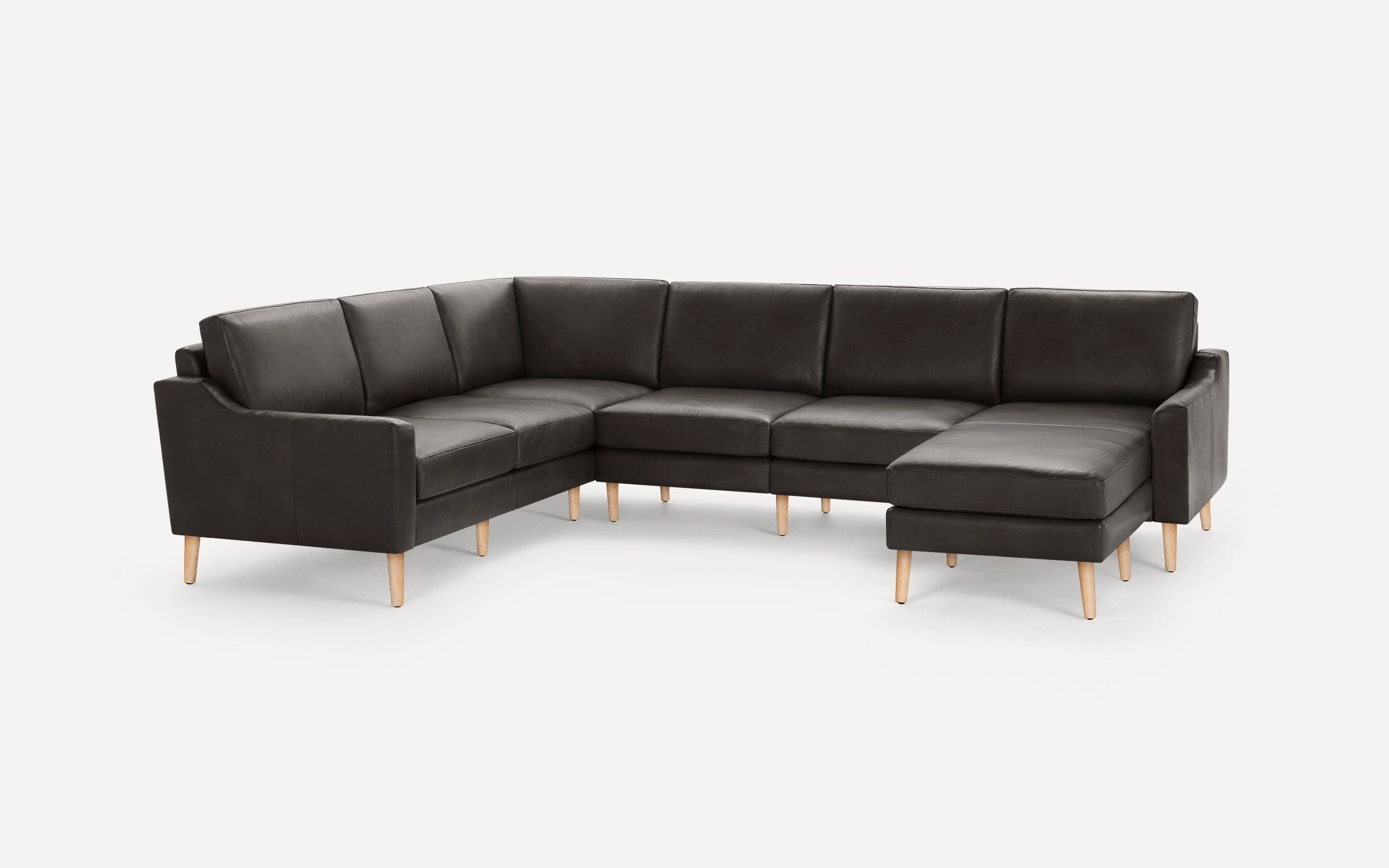 Modern U-shaped dark gray leather sectional sofa with clean lines and light wooden legs on a white background.