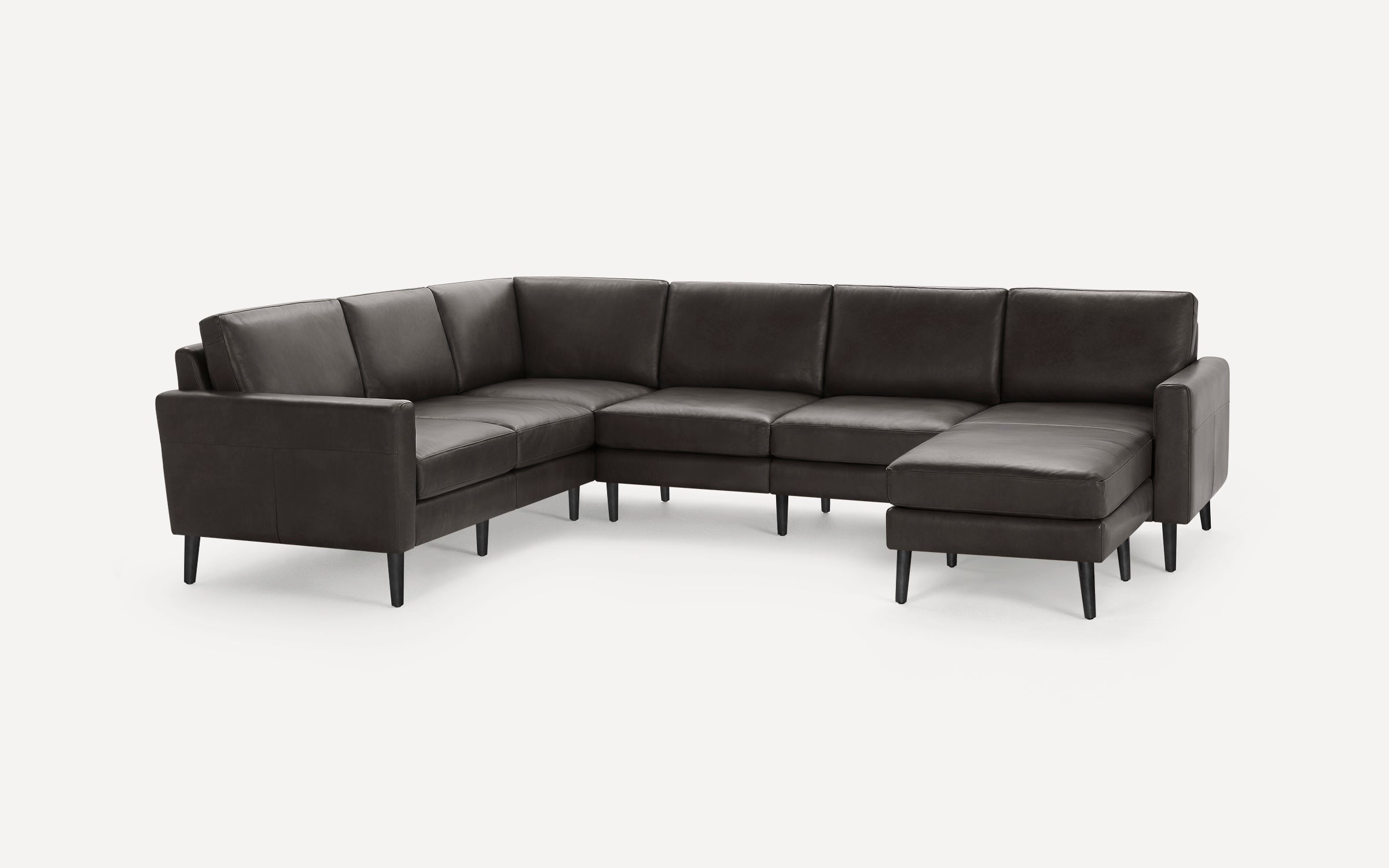 Dark gray L-shaped sectional sofa with sleek, modern design, cushioned seats, and black tapered legs on a white background.