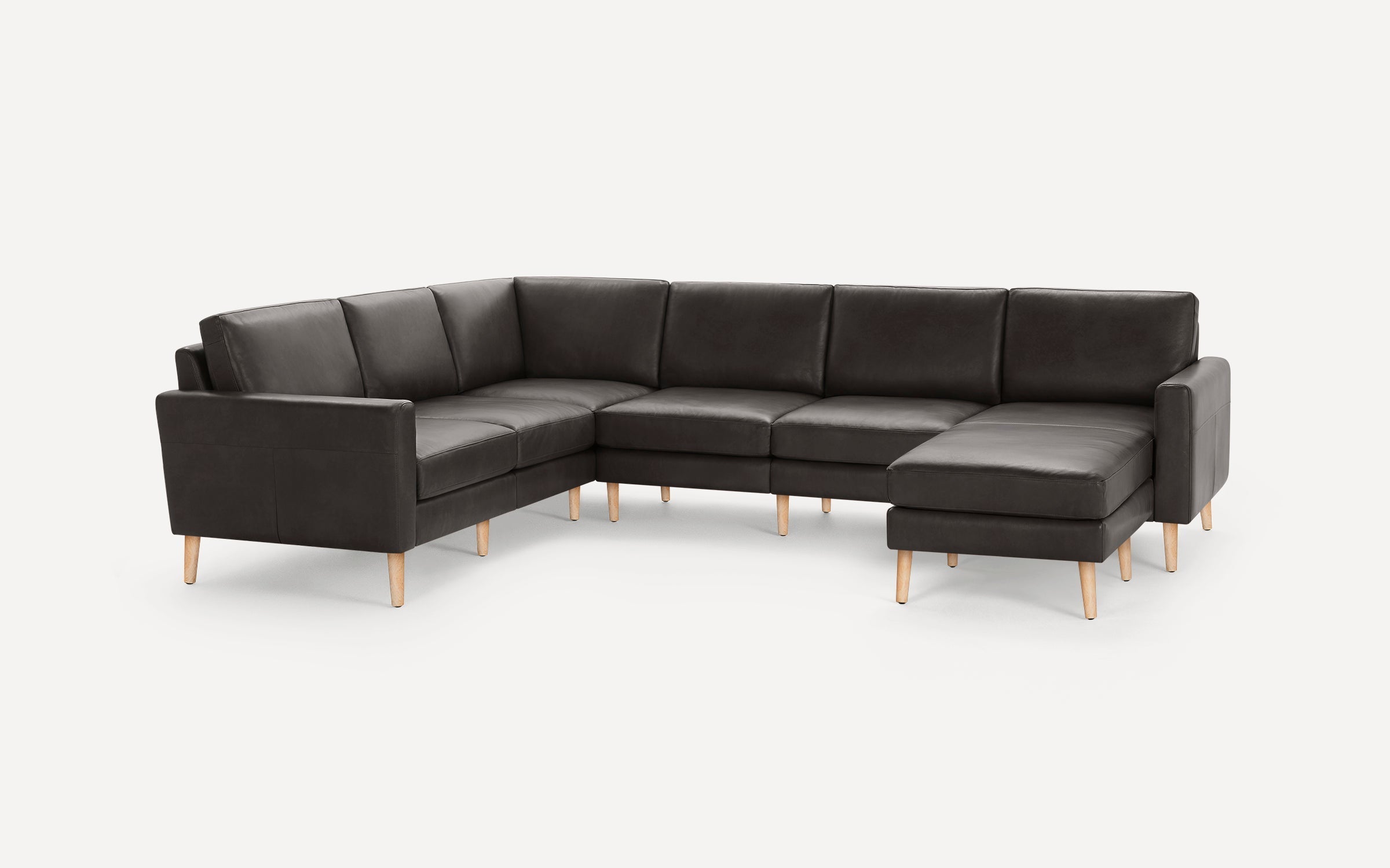 Modern dark gray leather sectional sofa with wooden legs, featuring a right-side chaise lounge and clean, minimalist design.