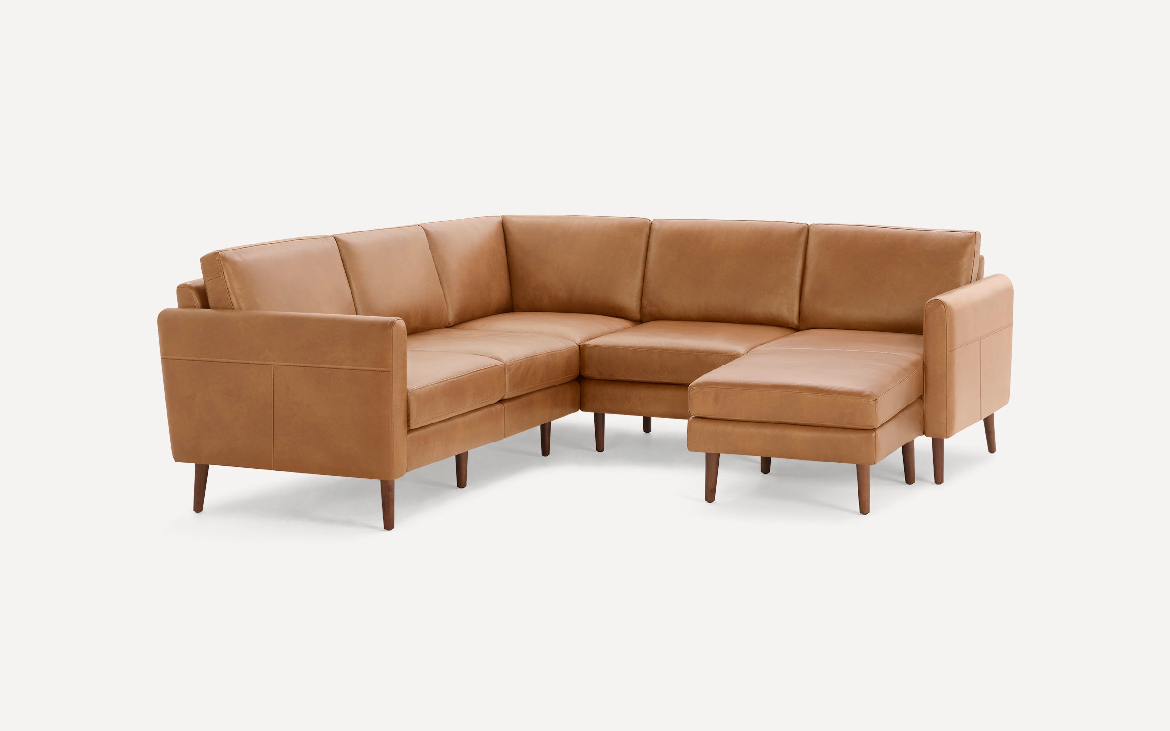 Light brown leather sectional sofa with wooden legs featuring a right-side chaise and clean, modern design.