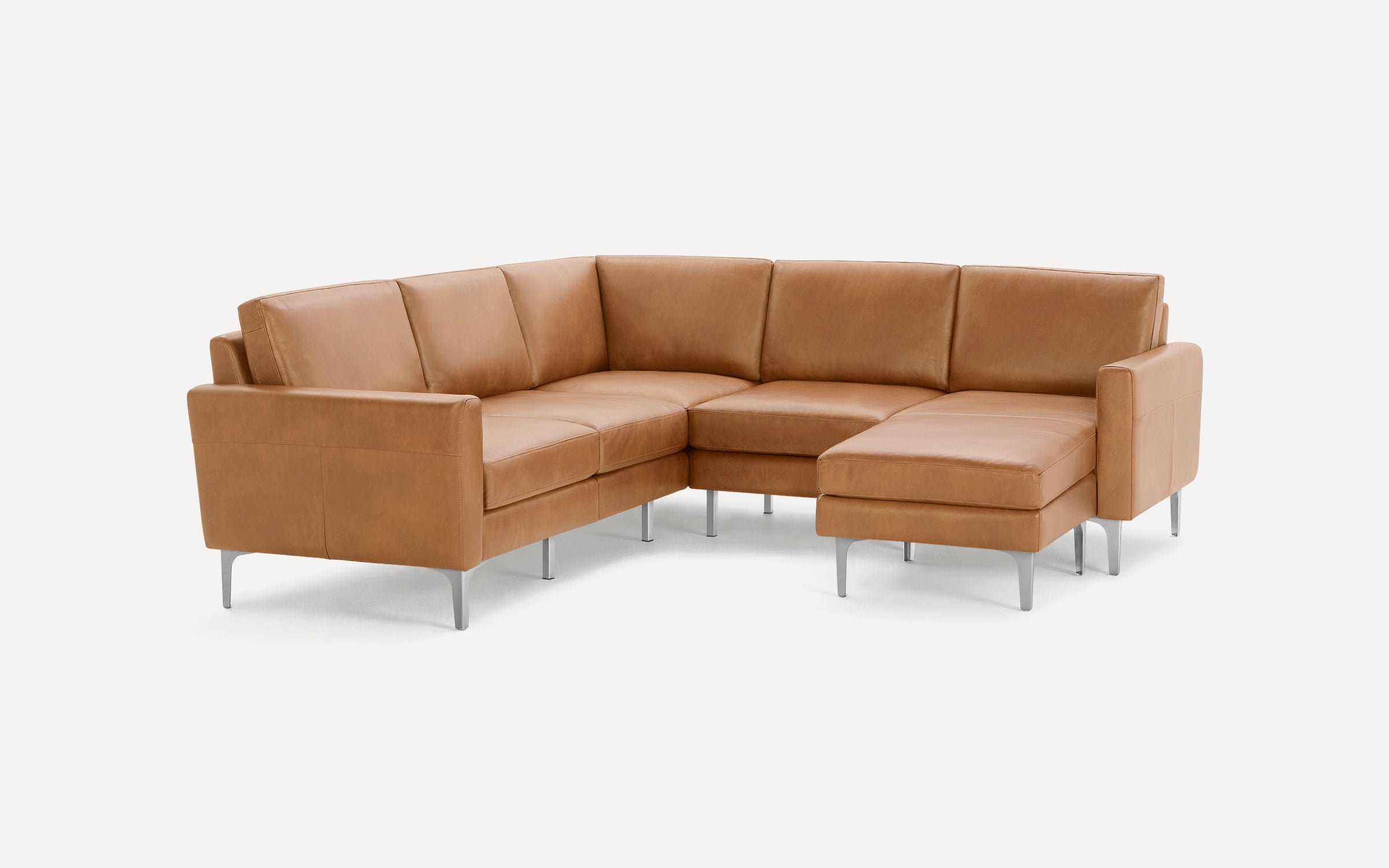 Modern L-shaped sectional sofa in light brown leather with sleek metal legs and cushioned seats and backrests.